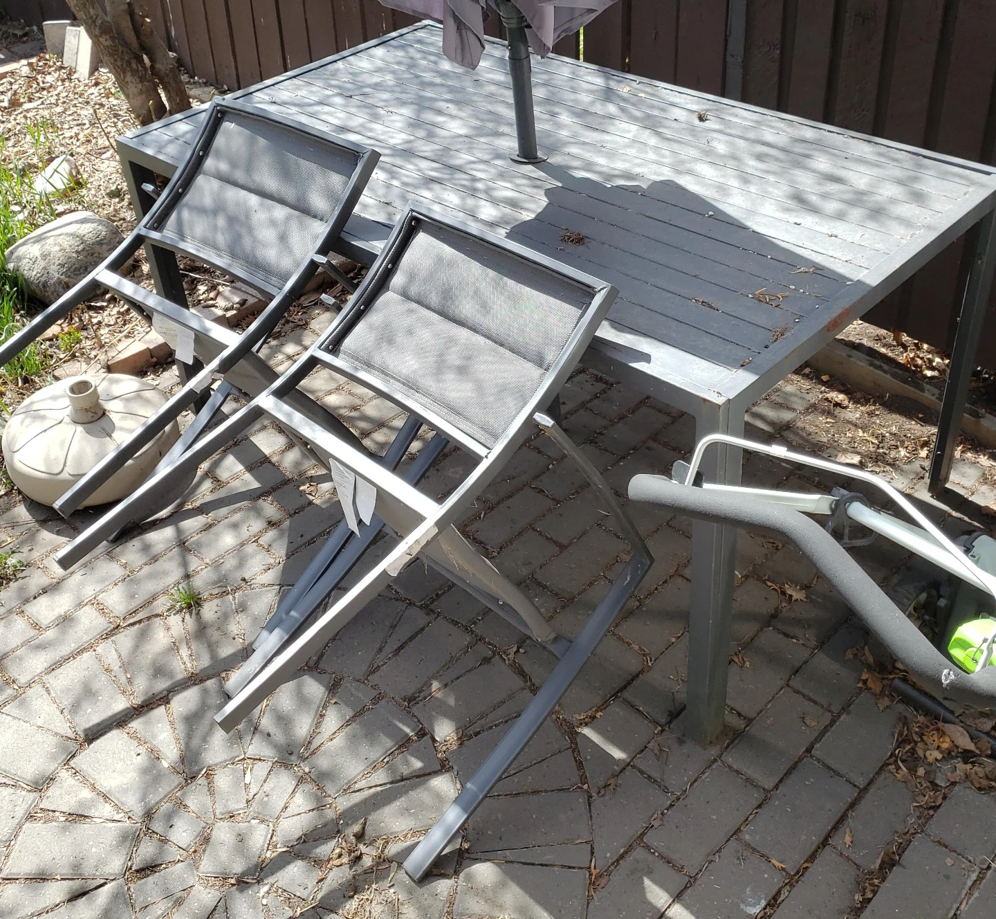 Grey Patio Table with Umbrella and Chairs