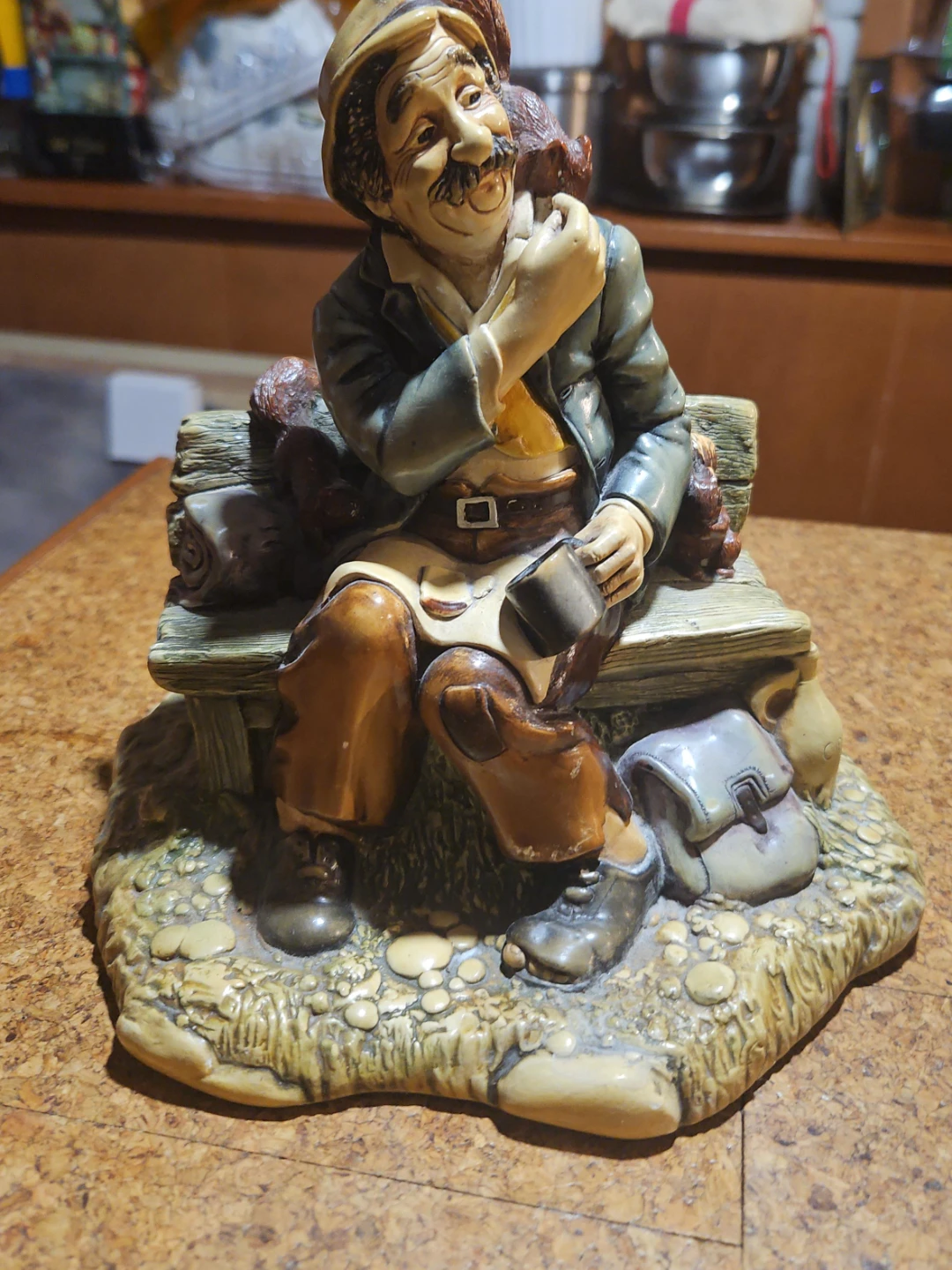Figurine of a man with a dog on a bench