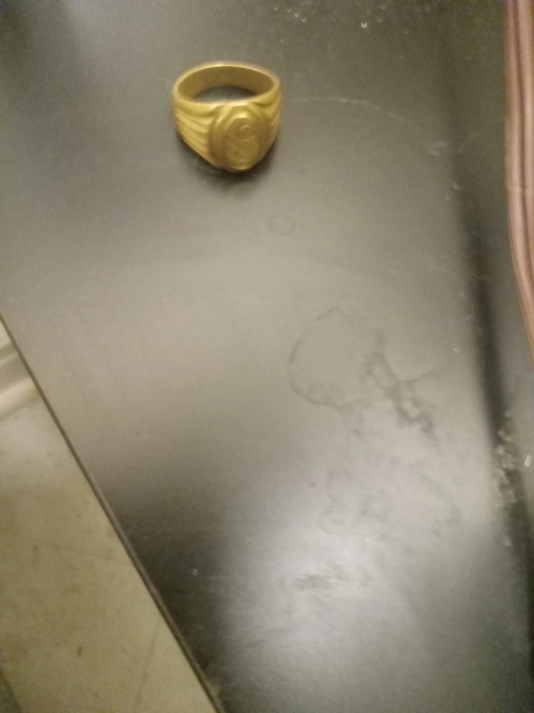 Gold coloured ring with emblem