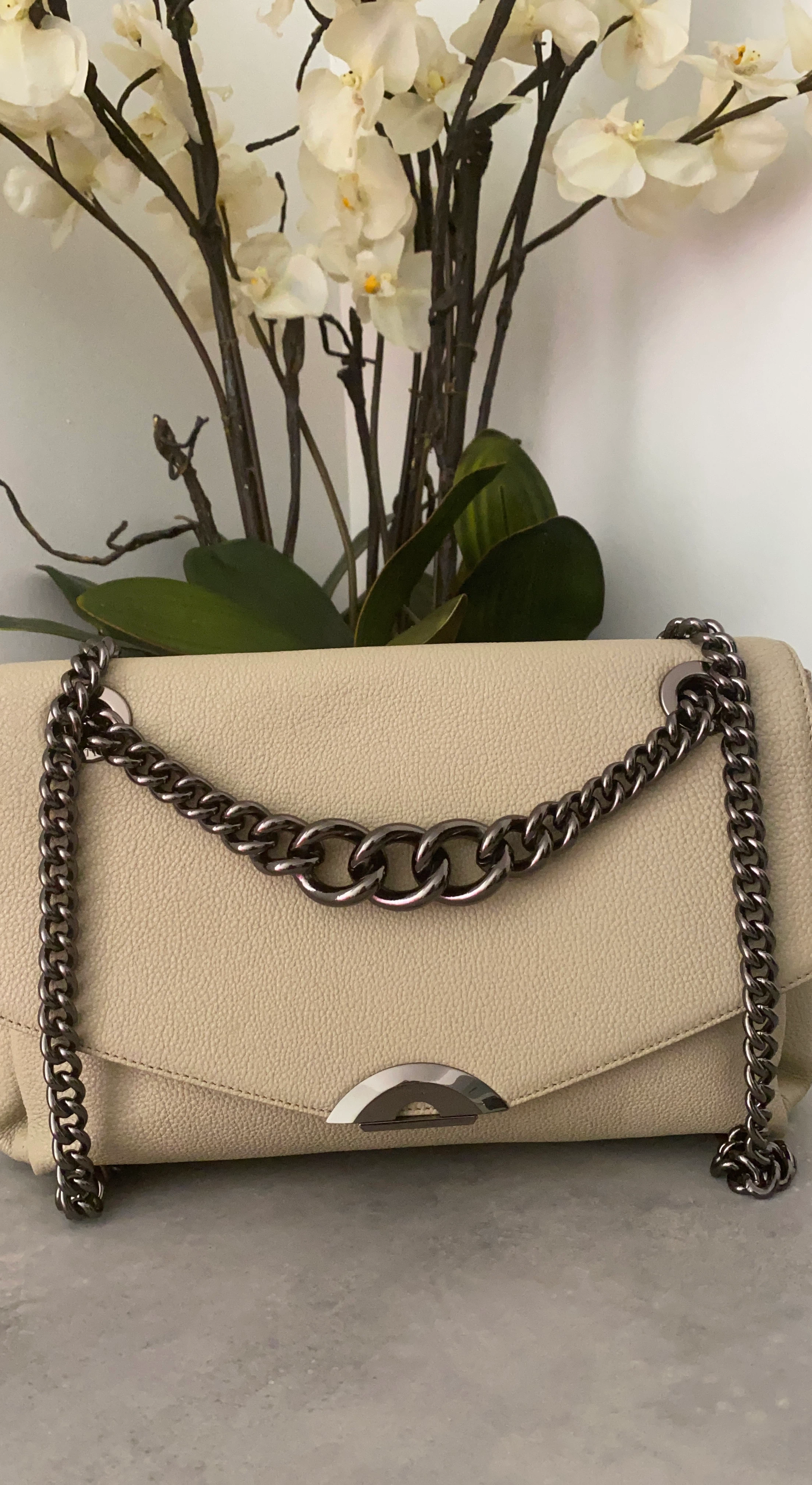 Cream crossbody purse with chain detail