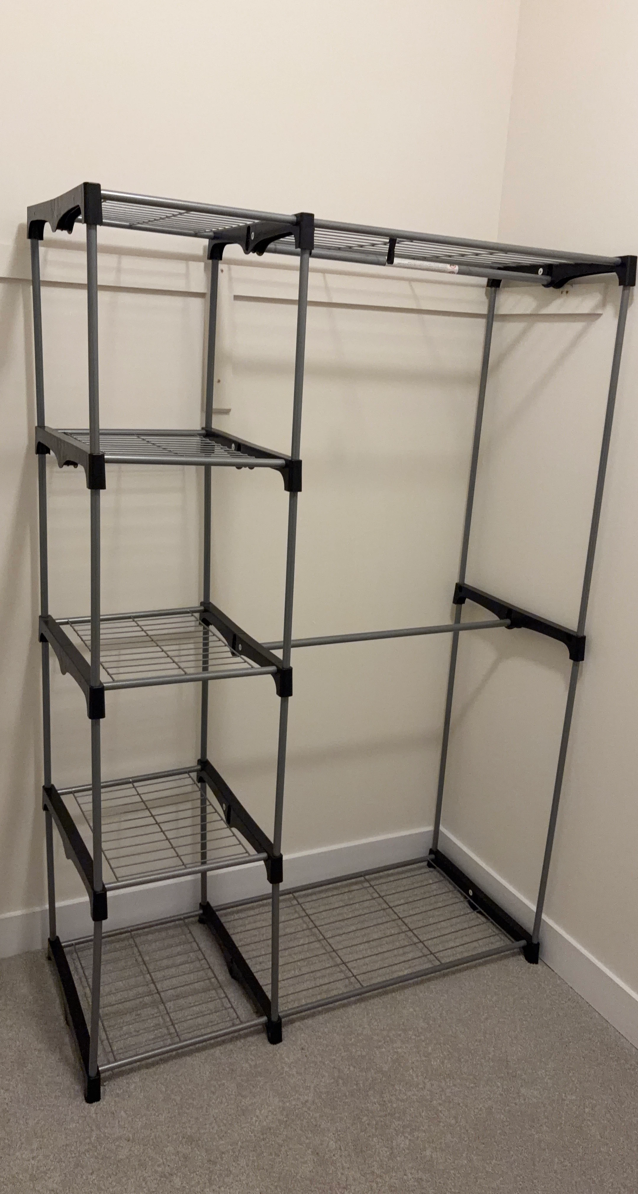 Grey metal garment rack with shelves