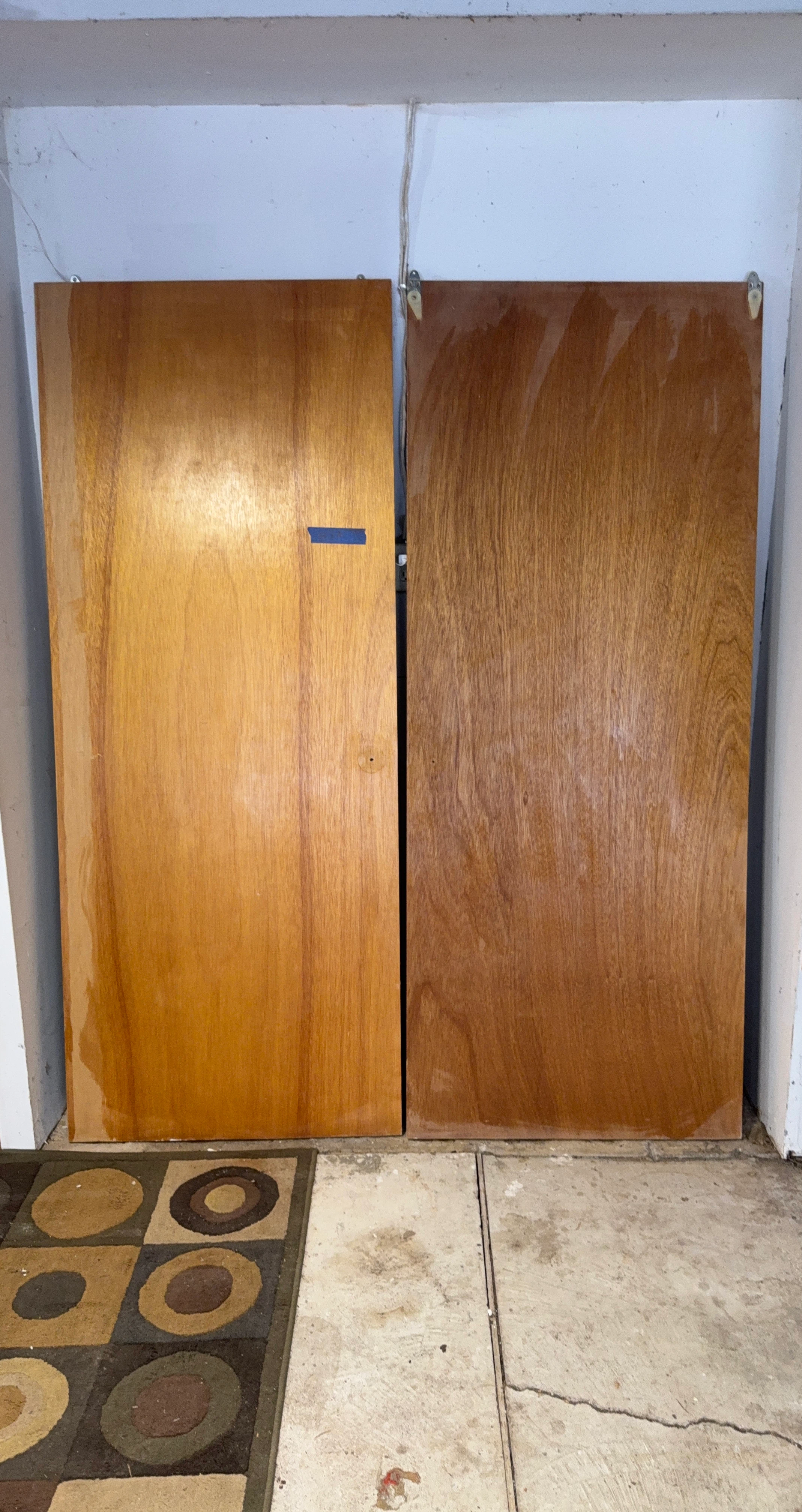 Two wood veneer closet doors
