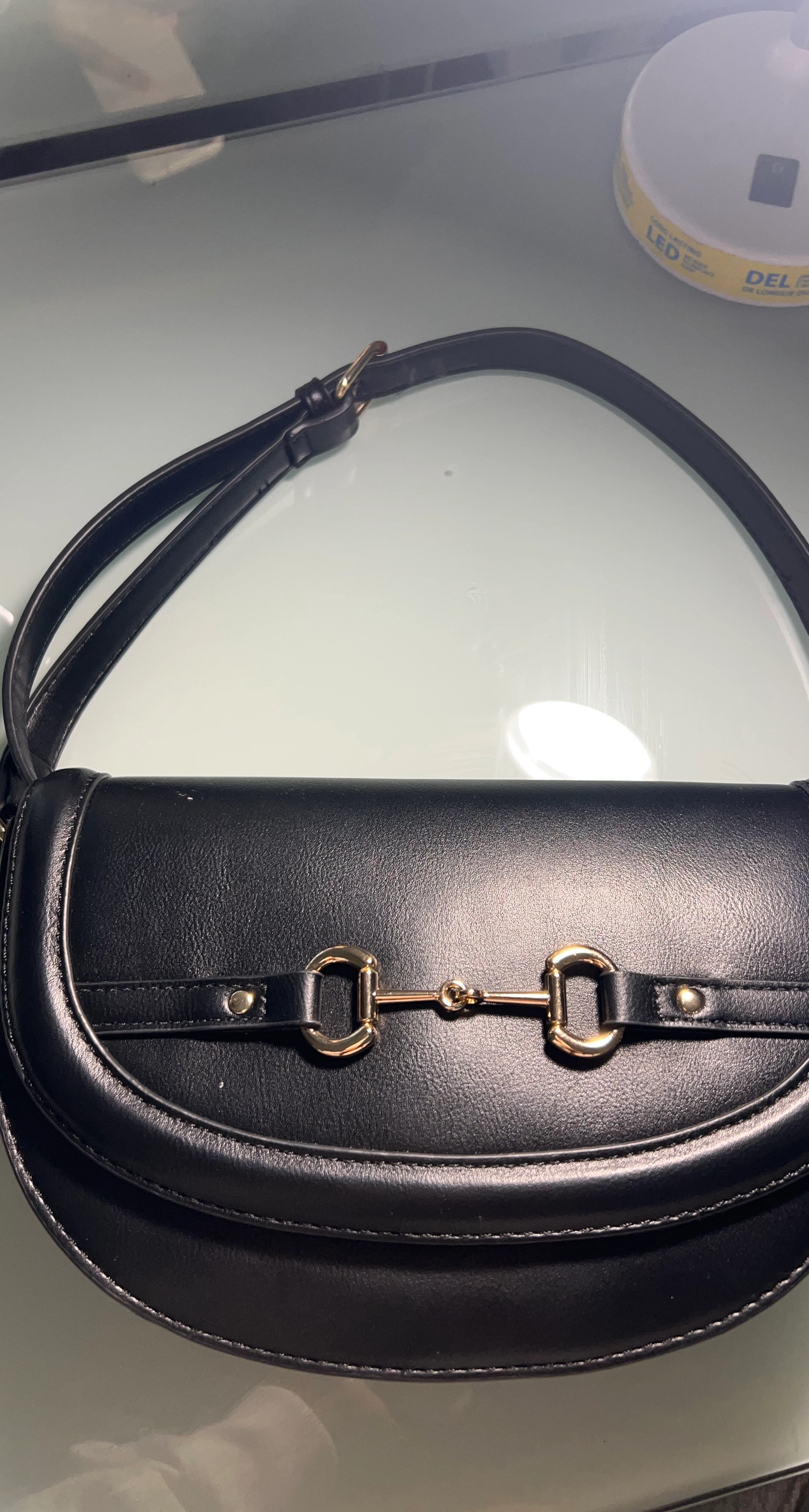 Black shoulder bag with gold hardware