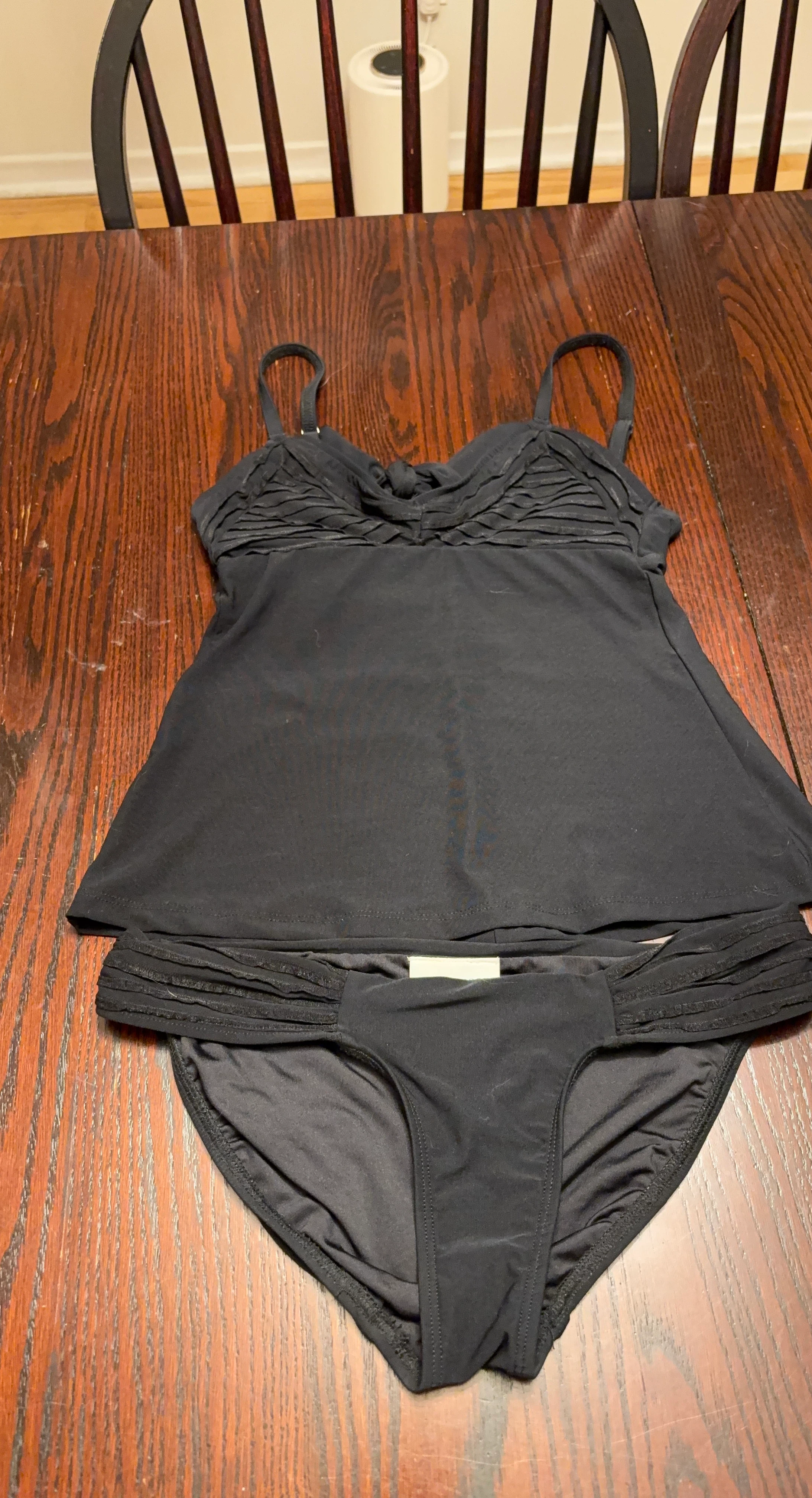 Black two-piece bathing suit and pink two-piece bathing suit
