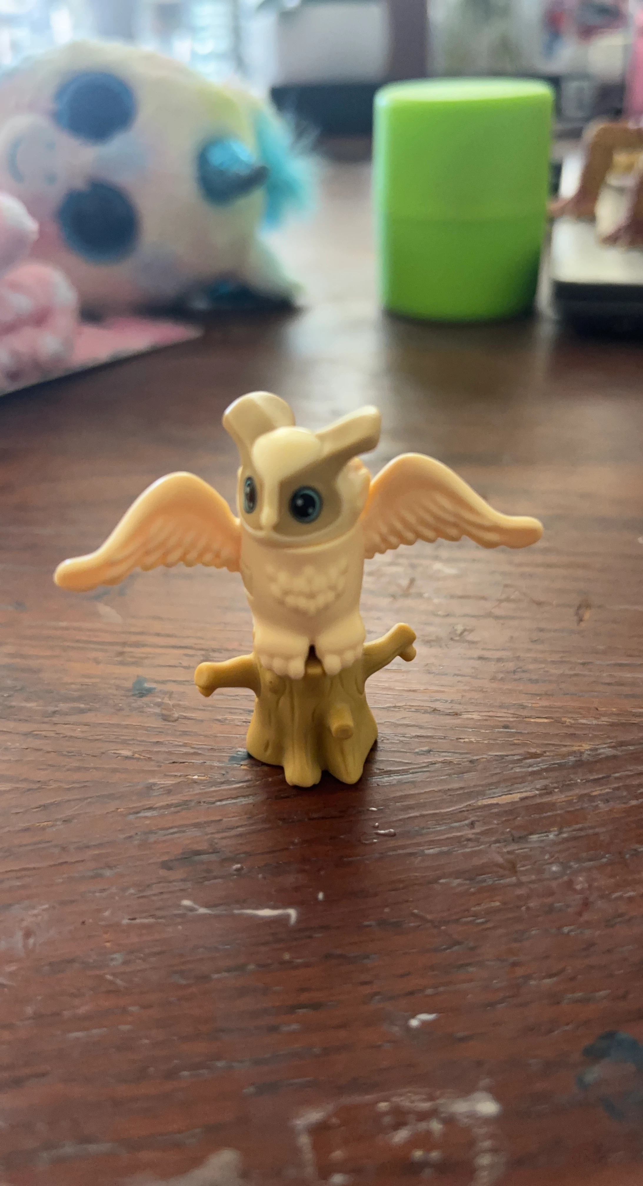 Plastic Owl Figurine on Tree Stump