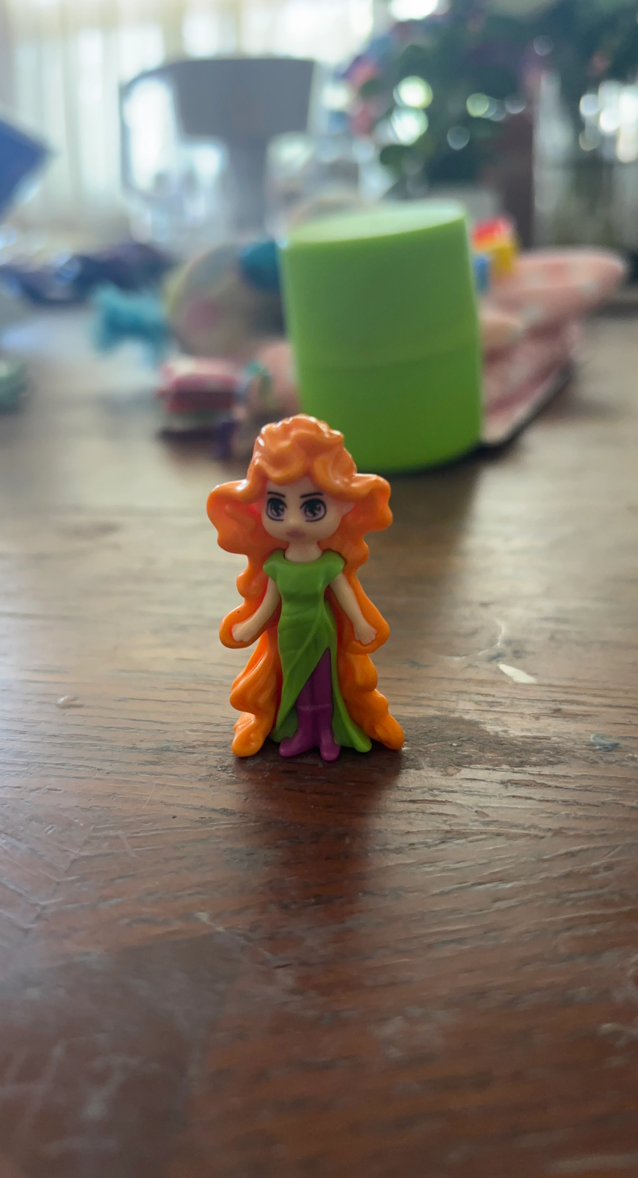 Miniature doll with orange hair and green dress