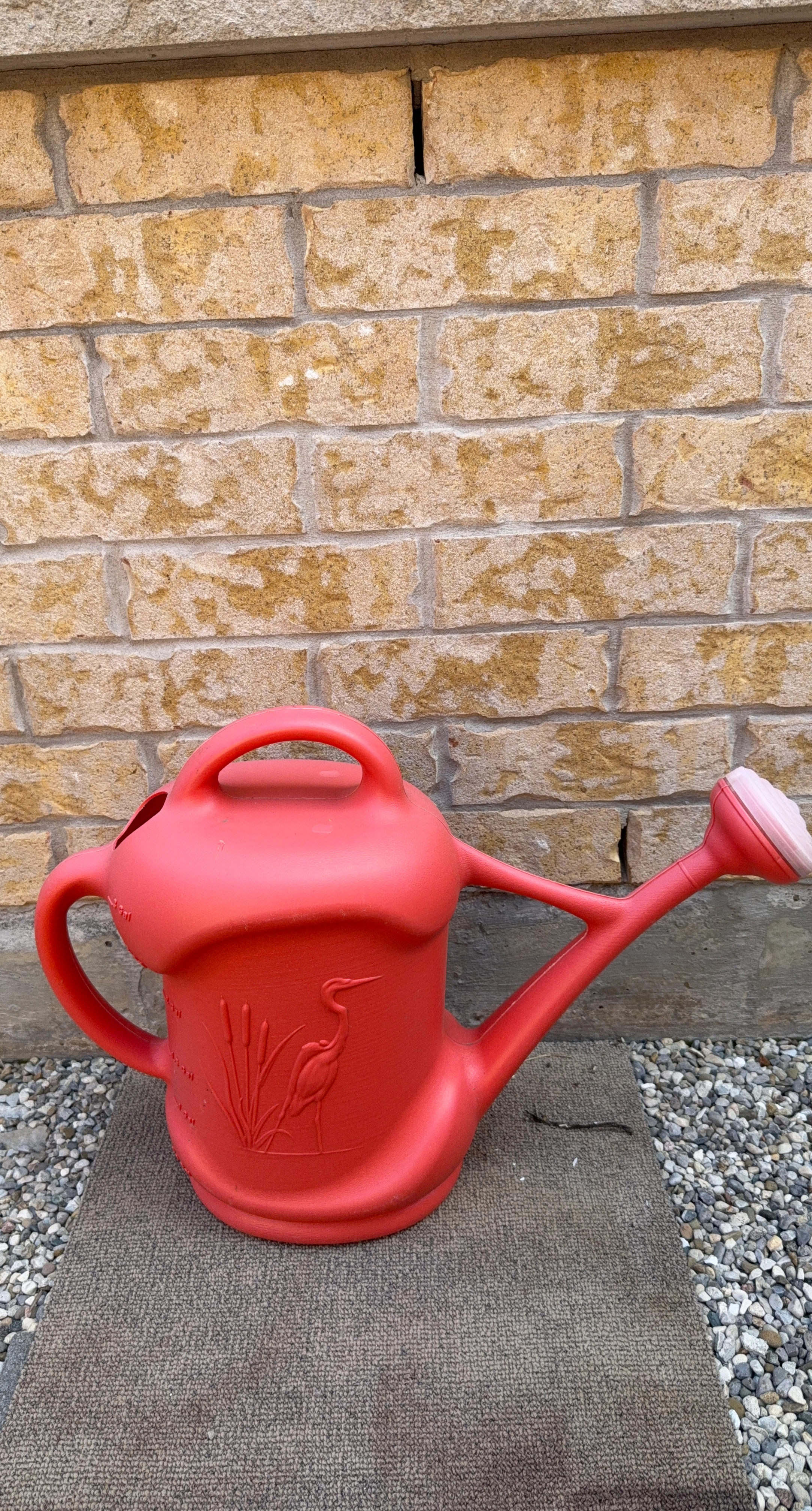 Red Watering Can with Crane Design