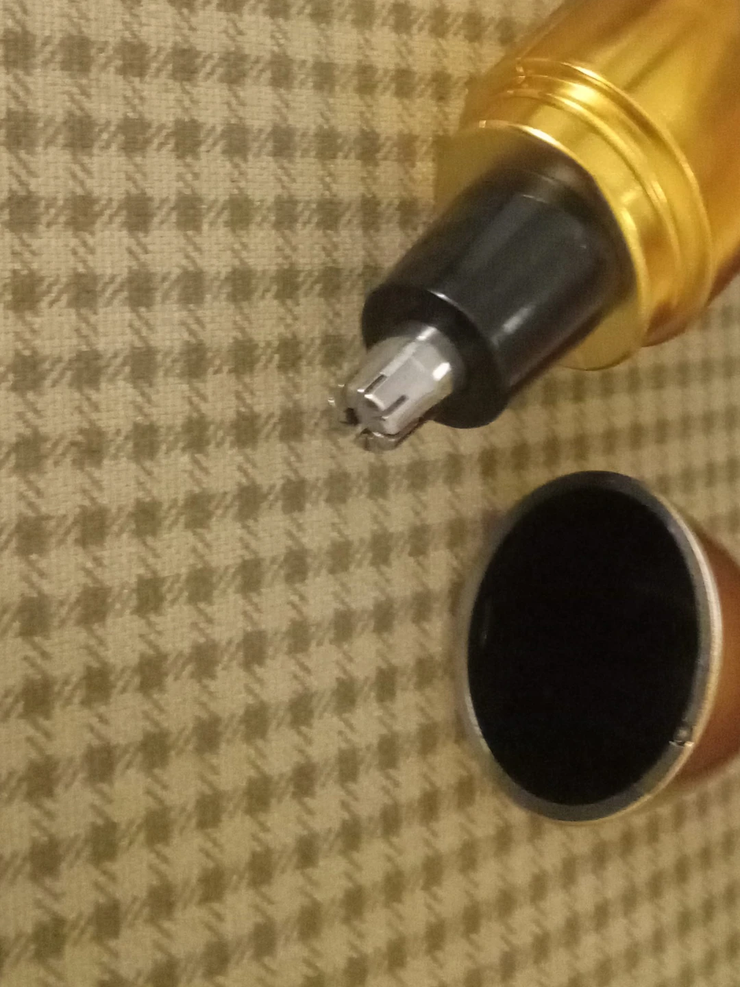 Gold coloured electric nose hair trimmer