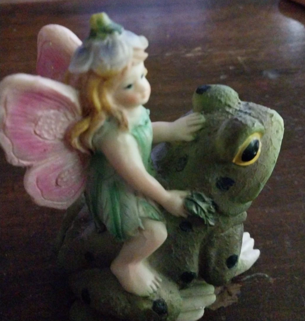 Fairy riding a frog figurine