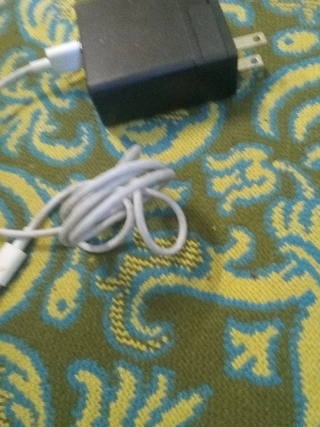 Black power adapter with white USB cable