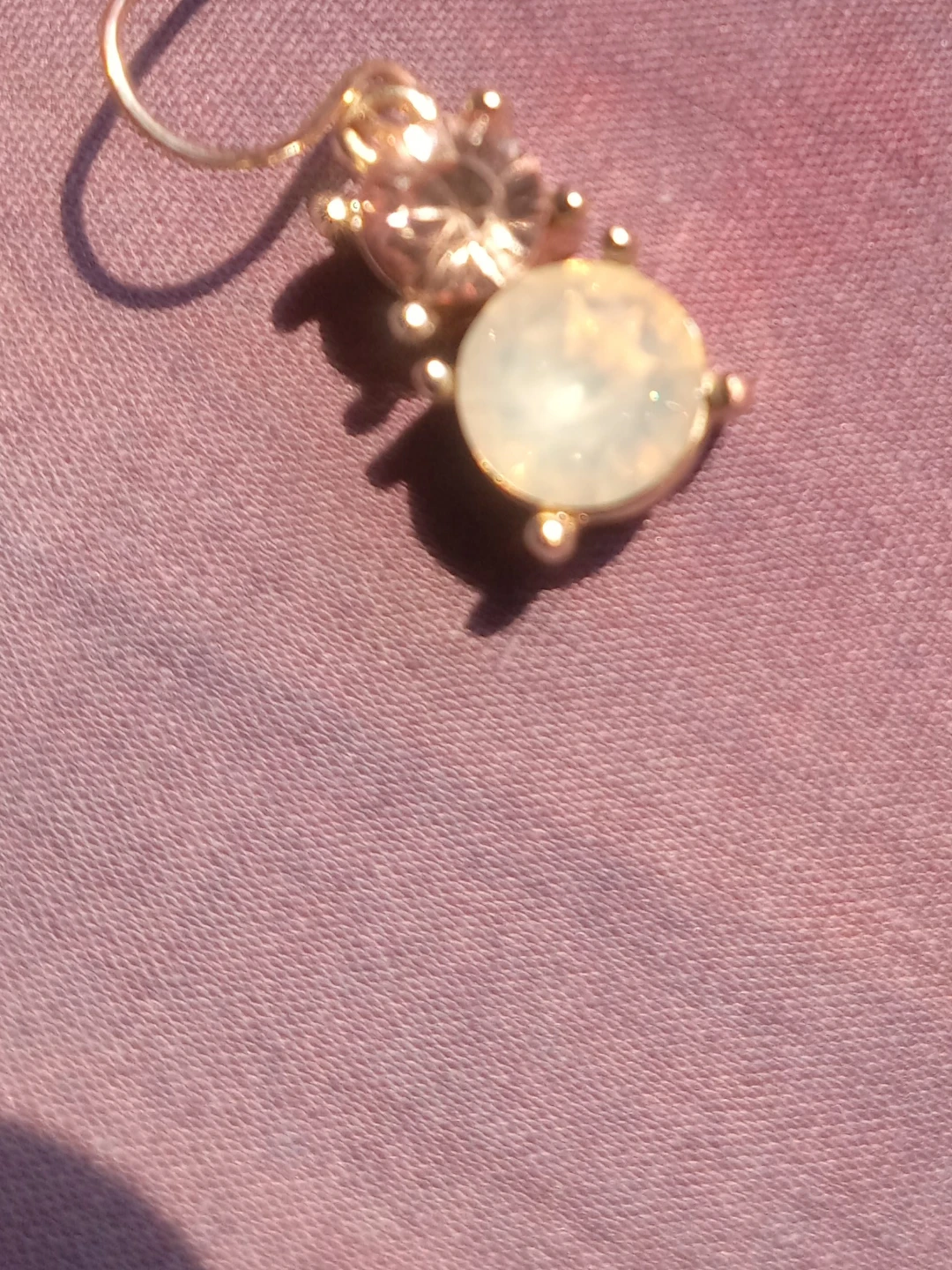 Gold-tone charm with iridescent stone