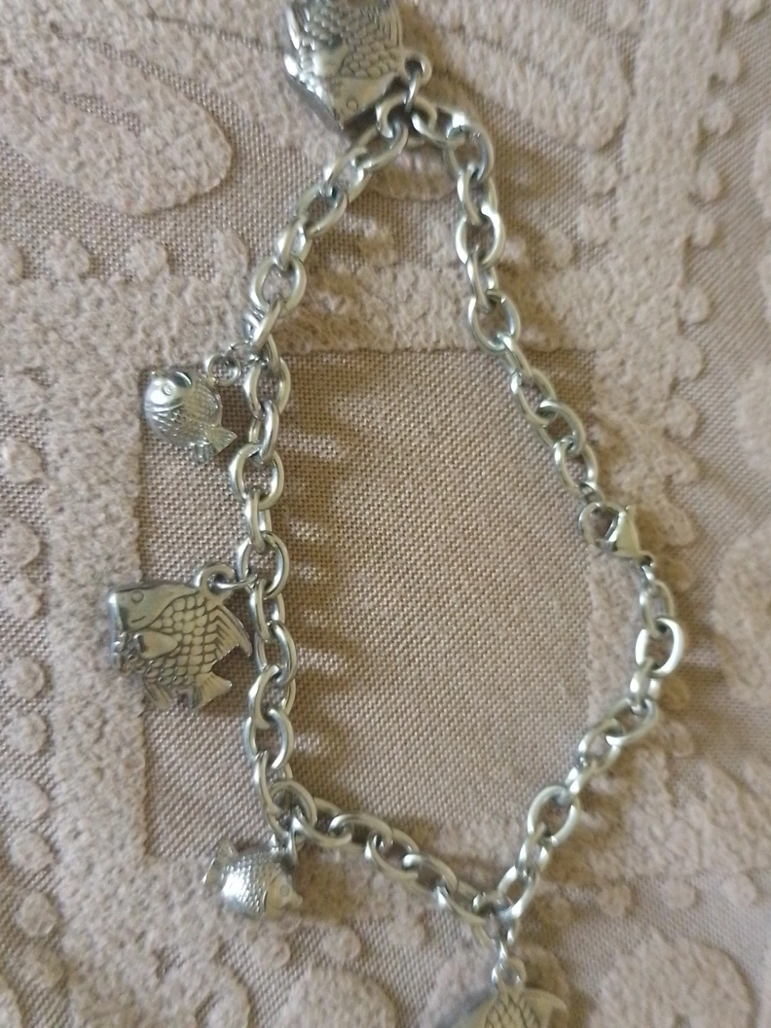 Silver-tone charm bracelet with fish