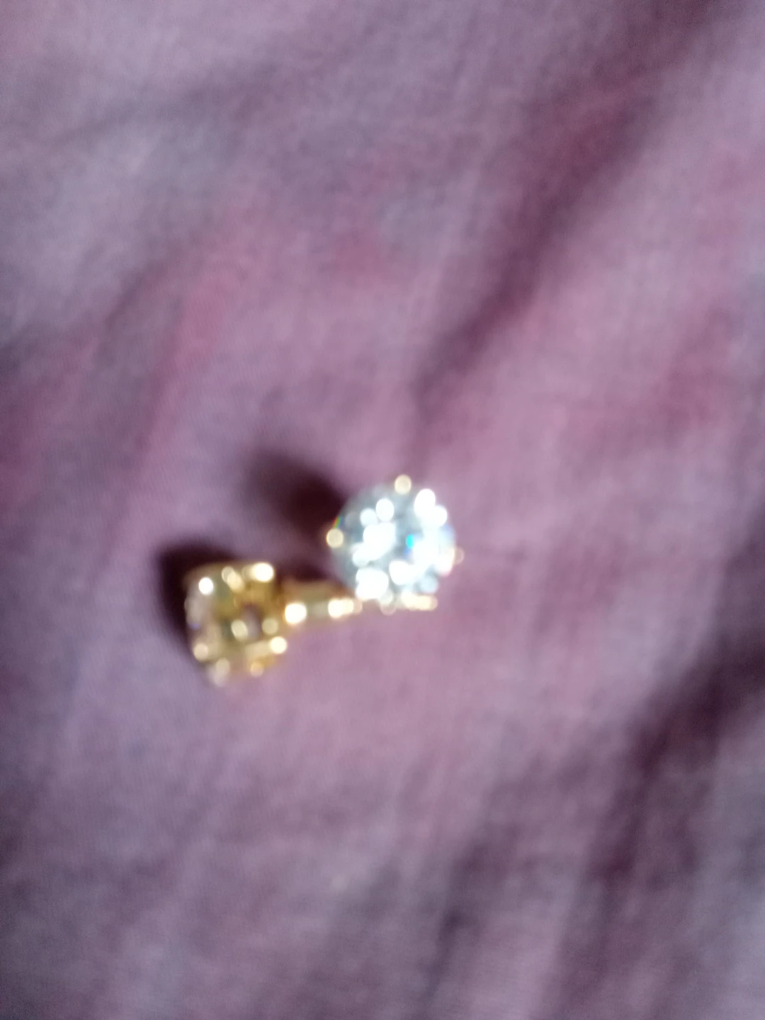 Gold-tone stud earring with a clear stone