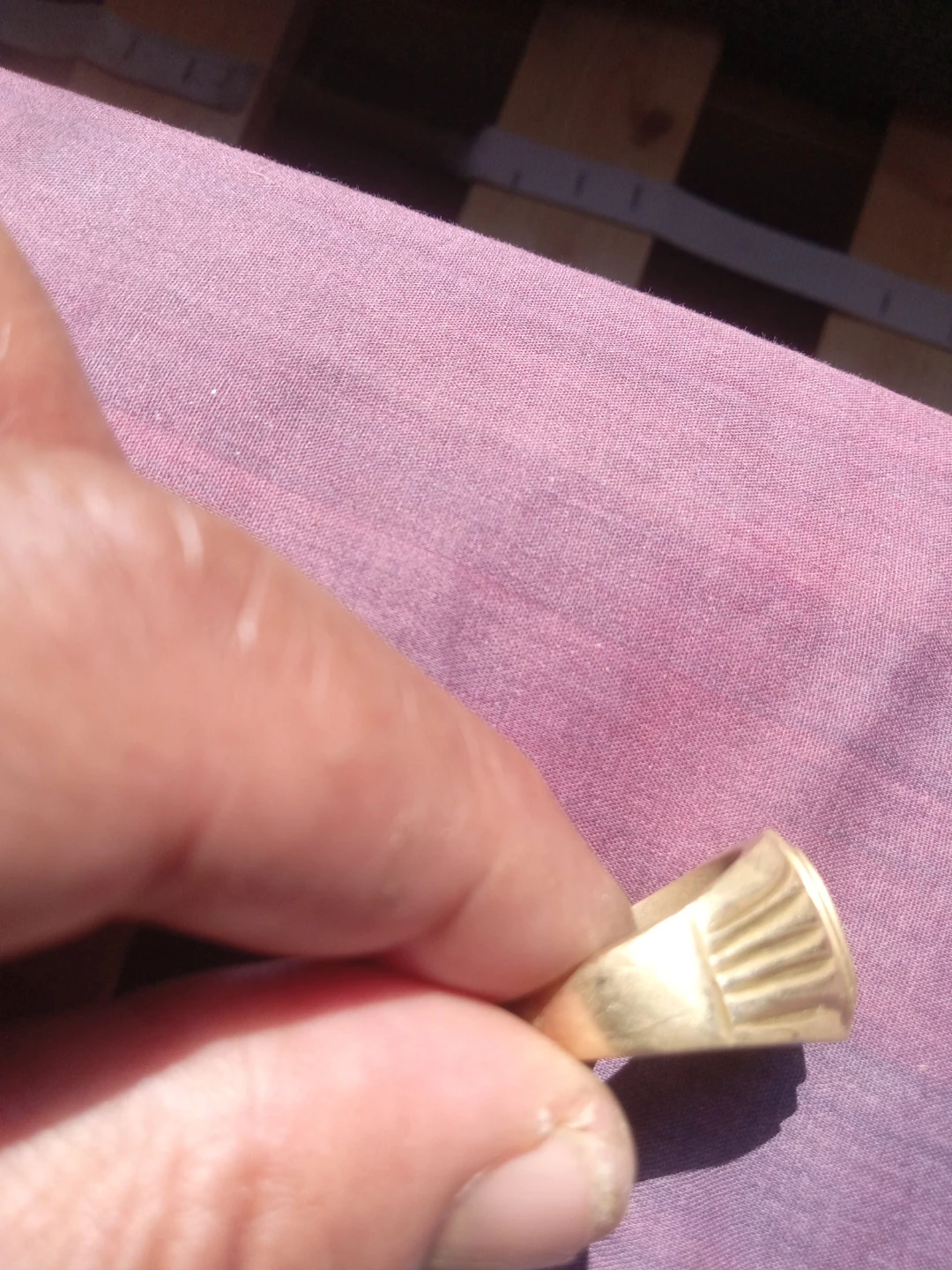 Gold coloured ring with patterned detail
