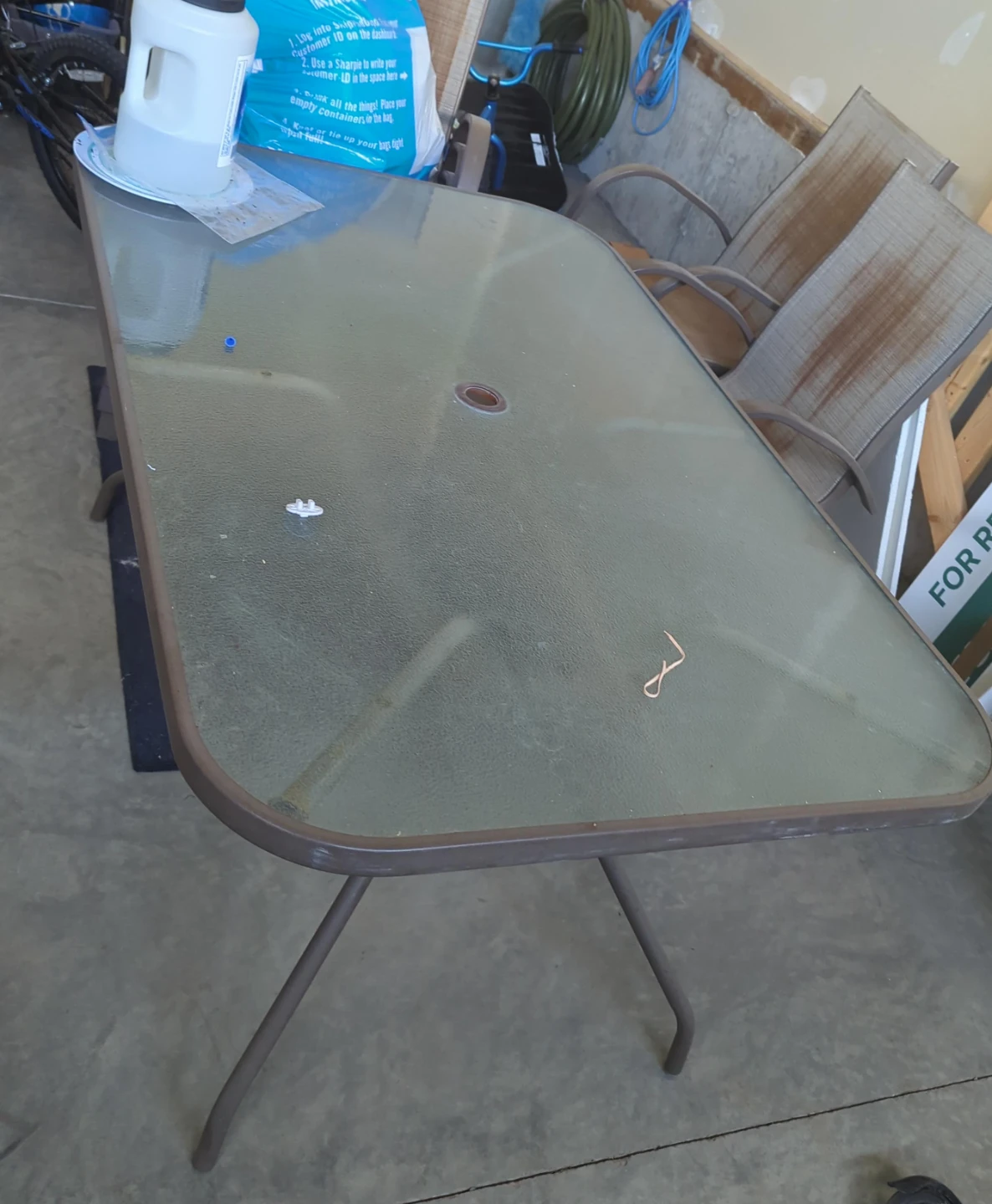 Glass top patio table with metal frame and chairs