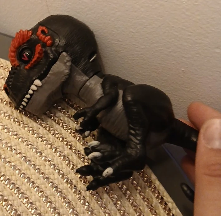 Black and red dinosaur toy