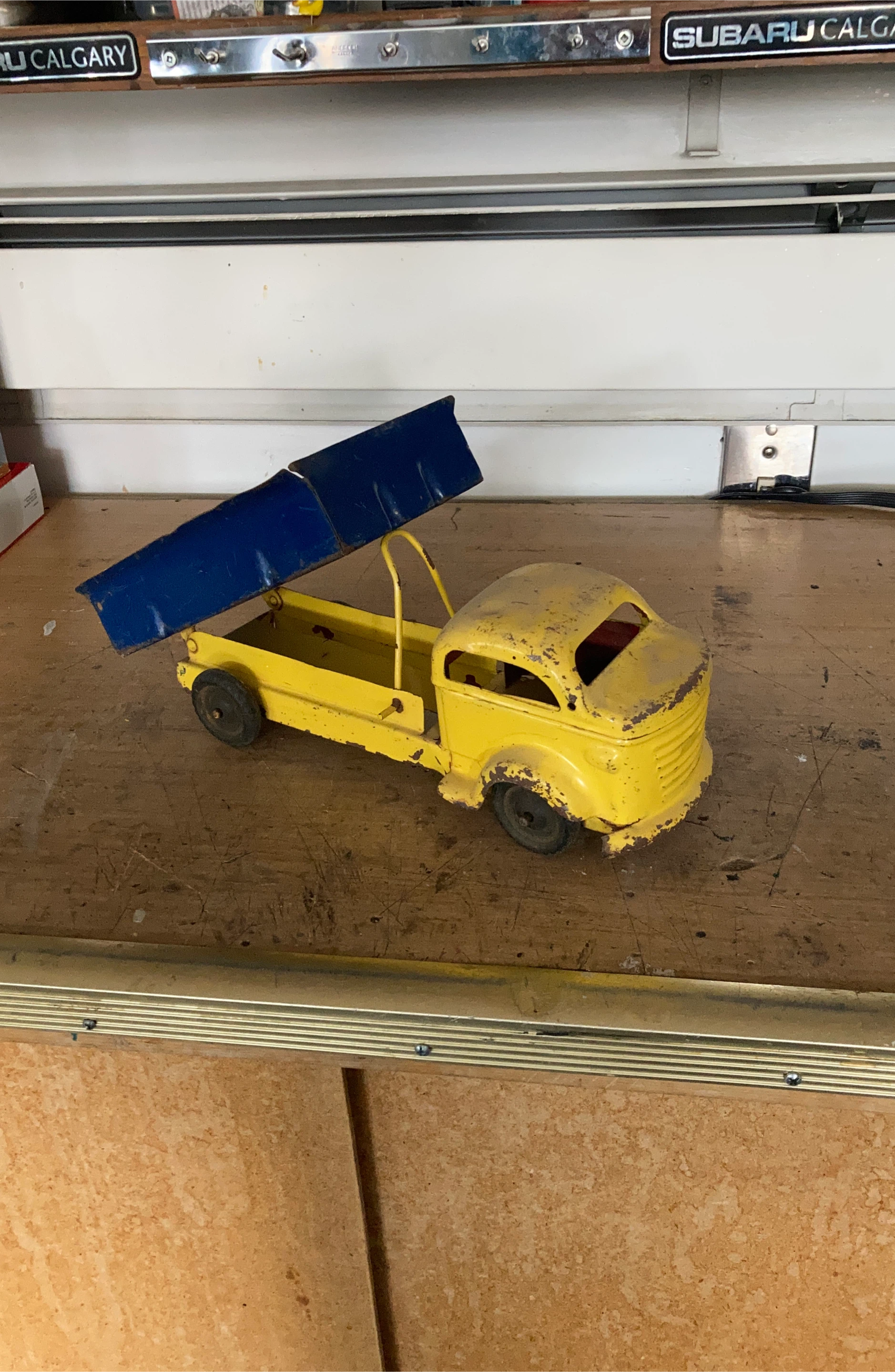 Yellow metal dump truck toy