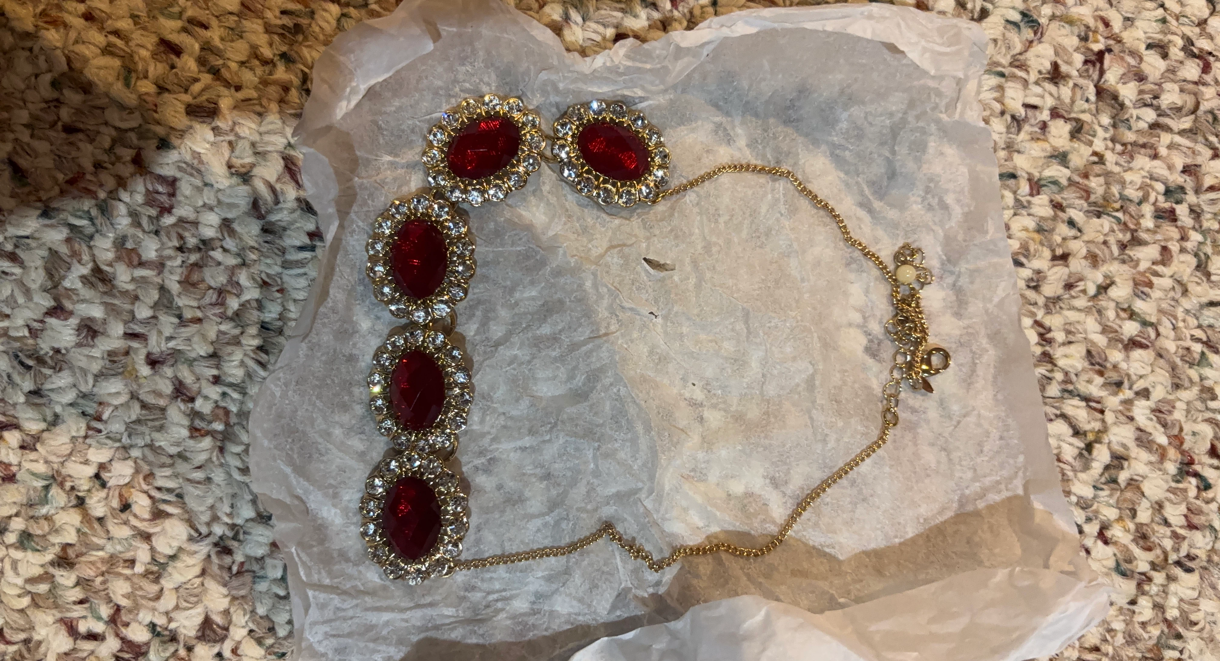 Gold-tone necklace with red and clear gems