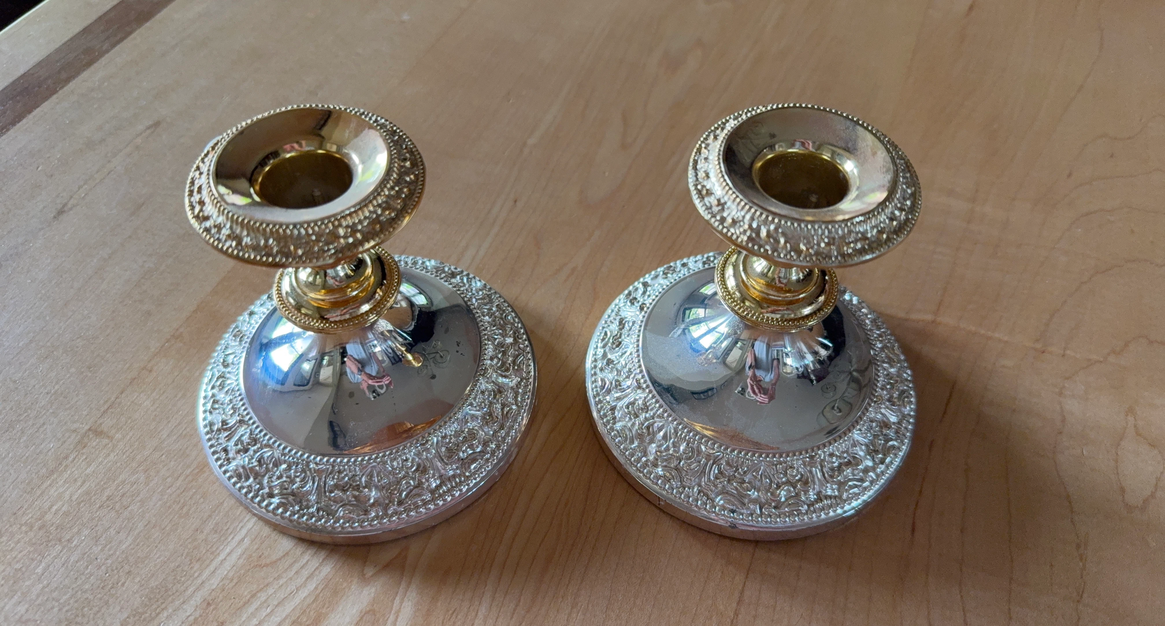 Pair of ornate silver and gold-tone candle holders