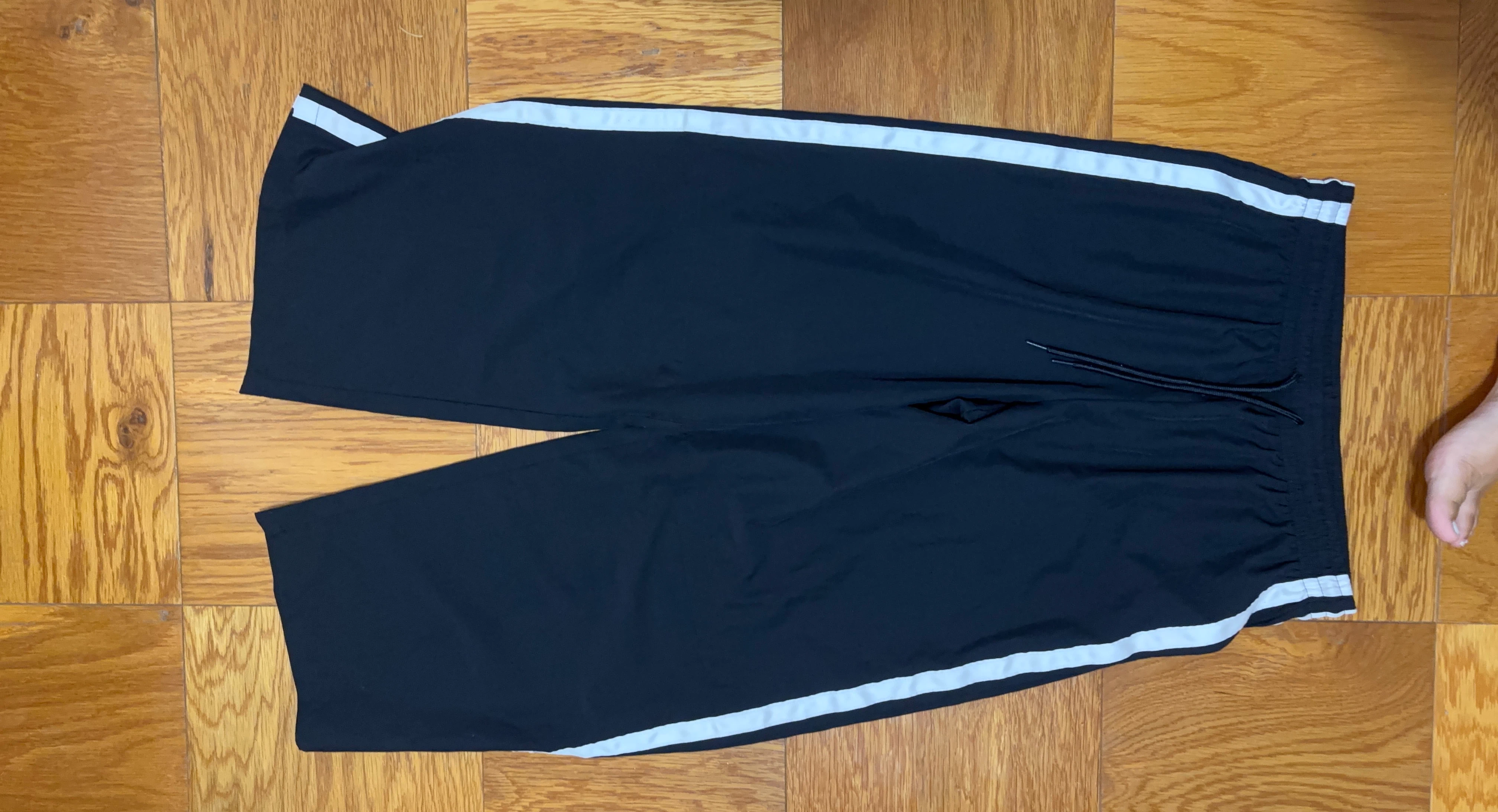 Black athletic shorts with white stripes