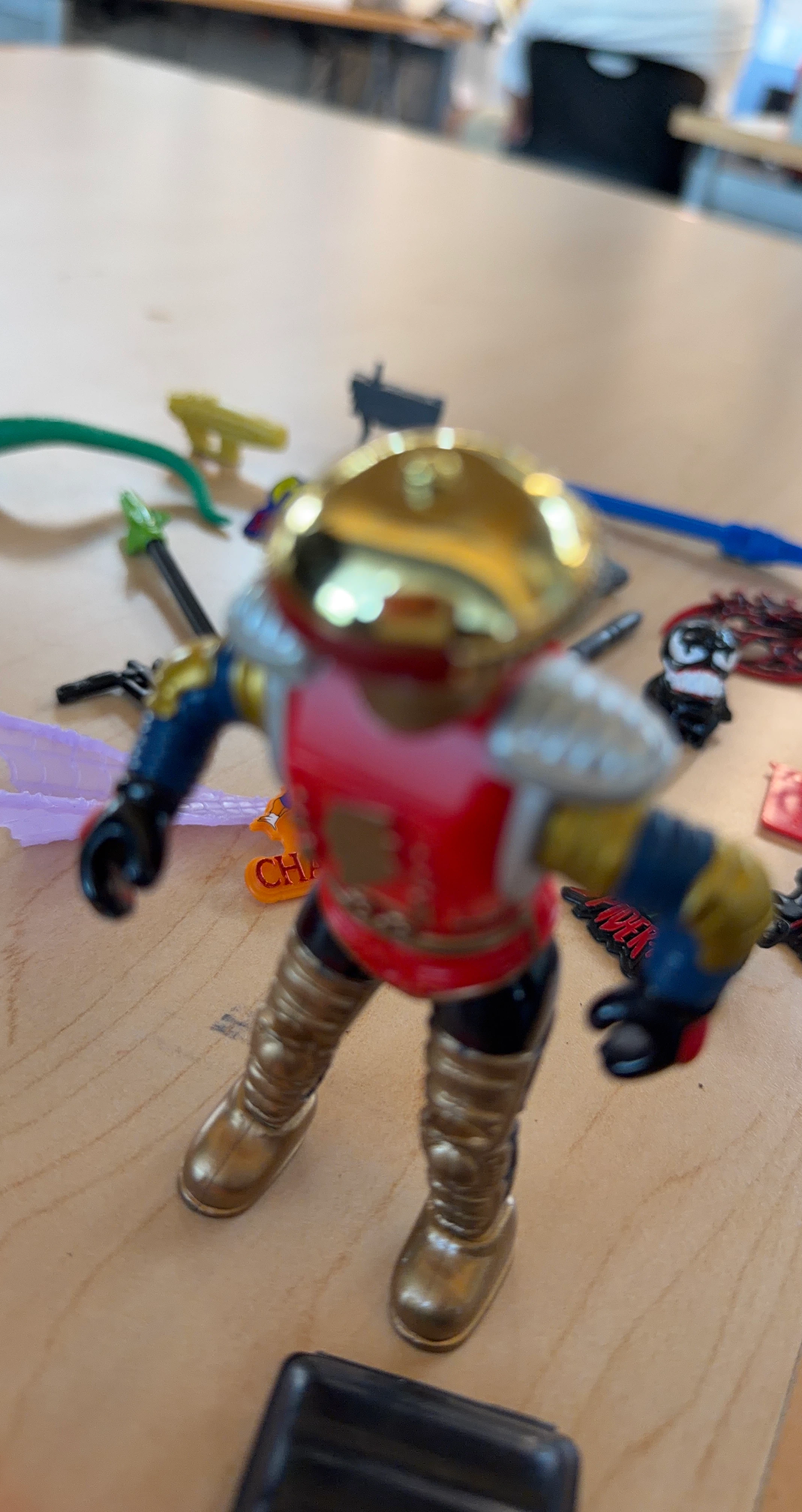 Action Figure with Gold Helmet and Red Armor