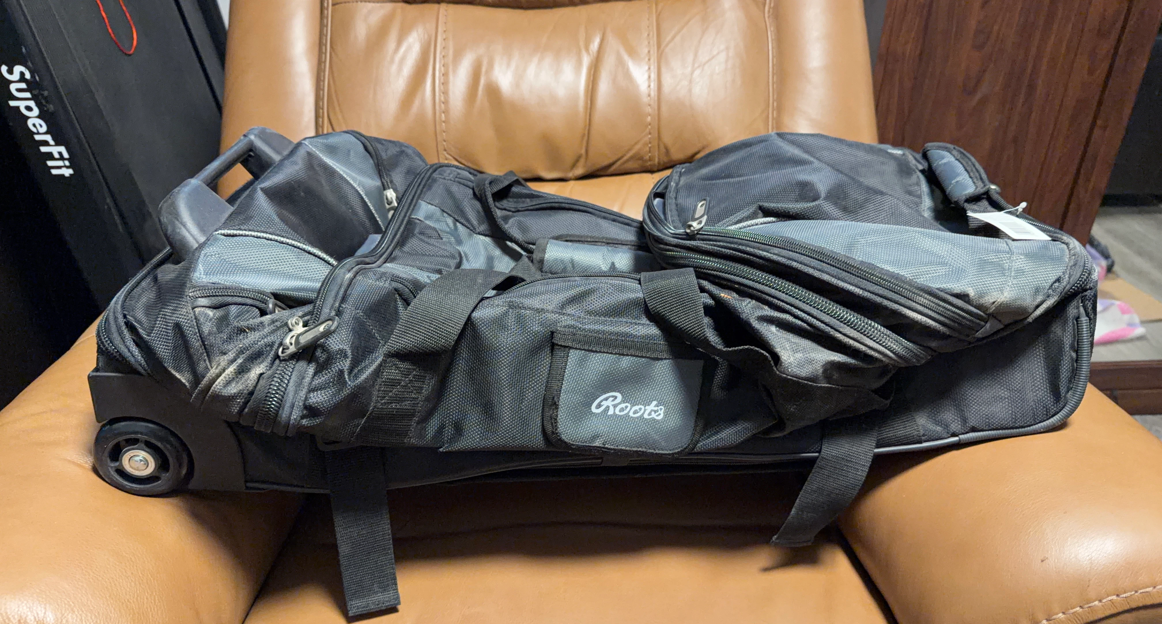 Roots Black Rolling Duffle Bag