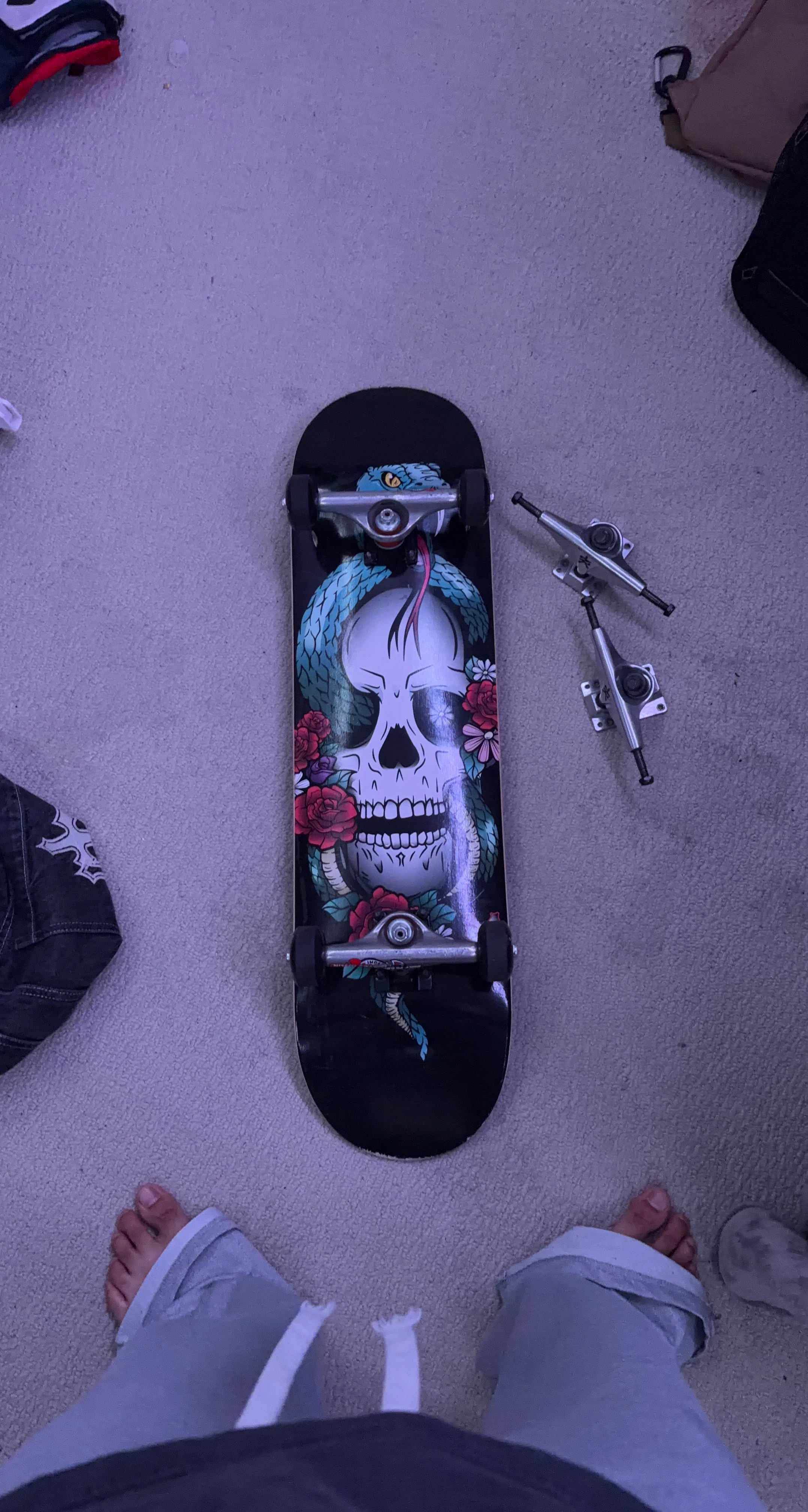 Skateboard with Skull and Snake Graphic