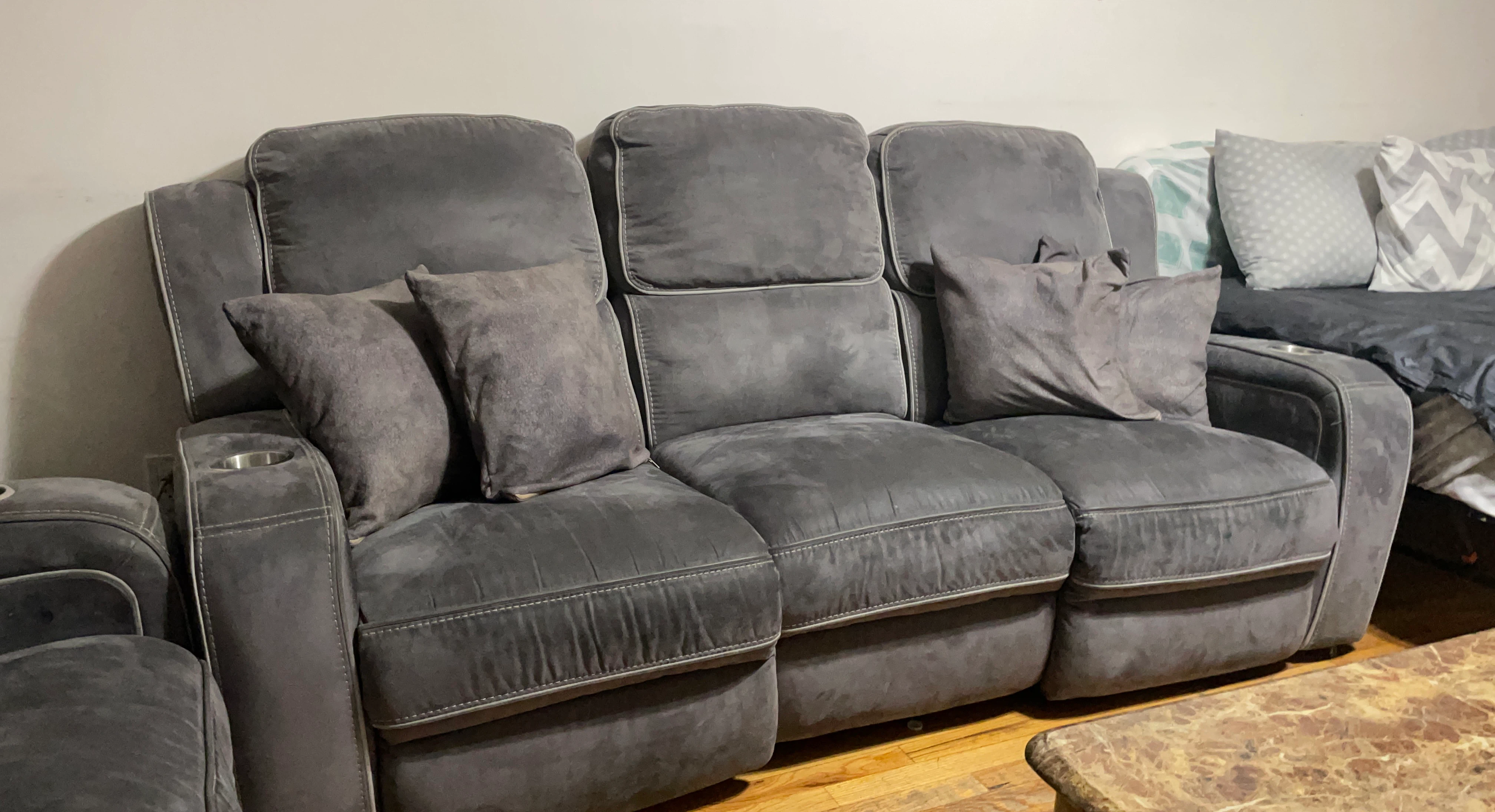 Gray reclining sofa with cup holders