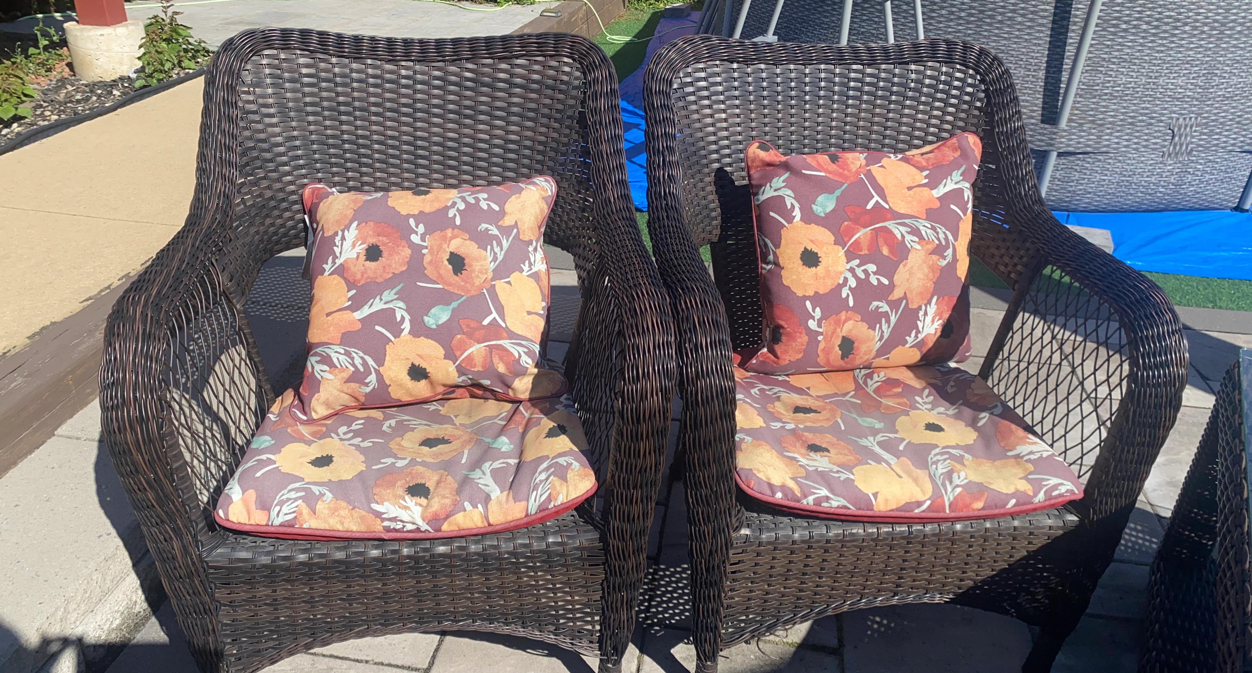 Wicker patio chairs with floral cushions
