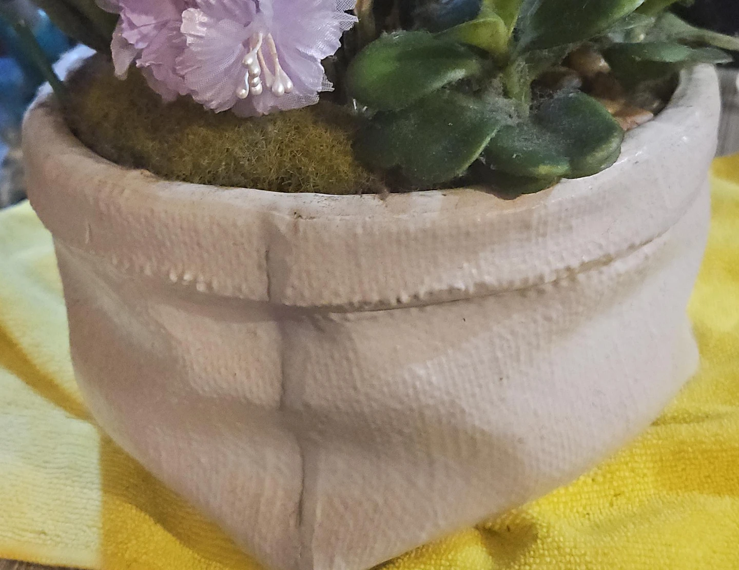 Decorative planter with crucifix and faux plants