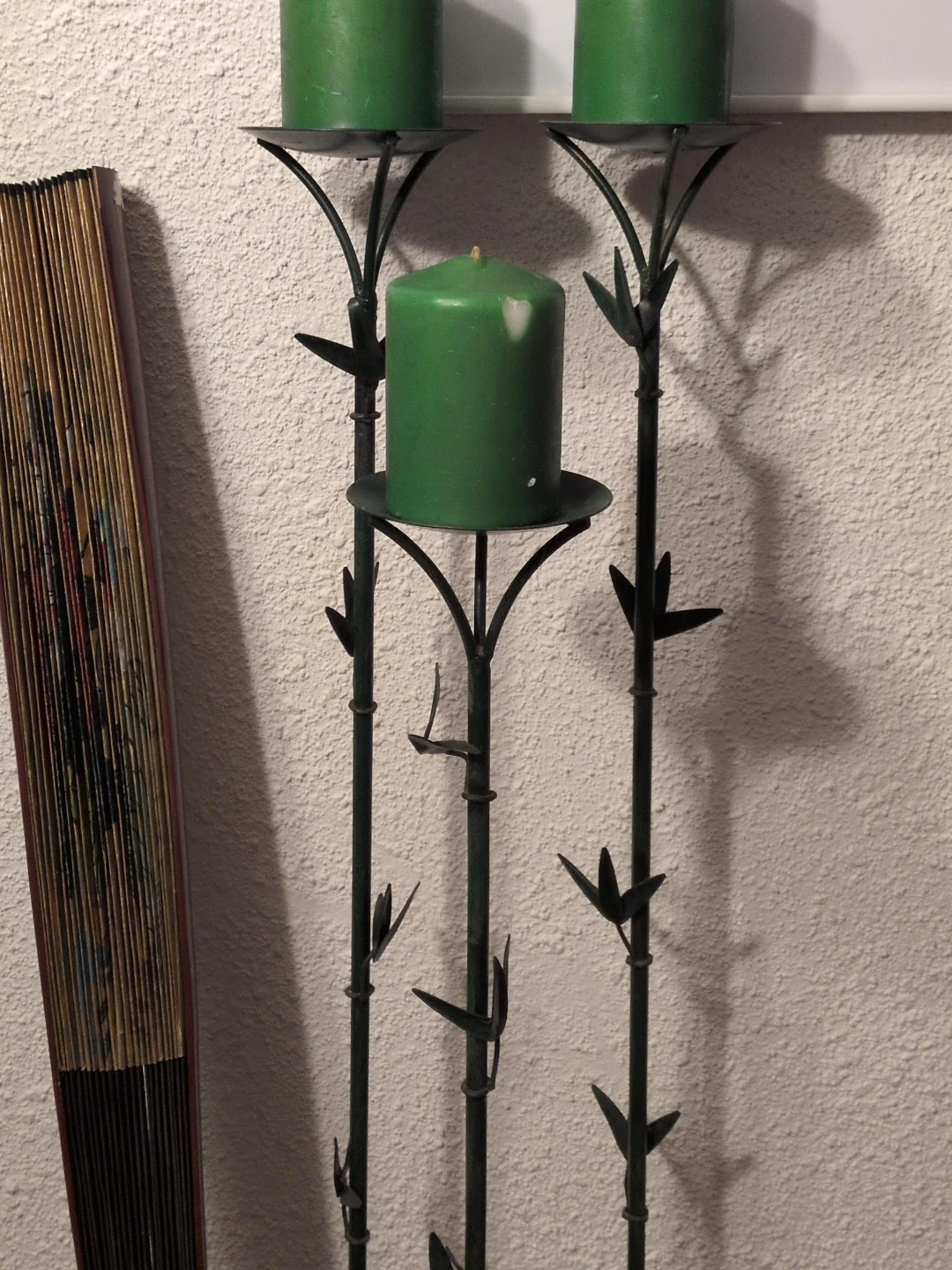 Green Pillar Candles on Black Metal Candelabra