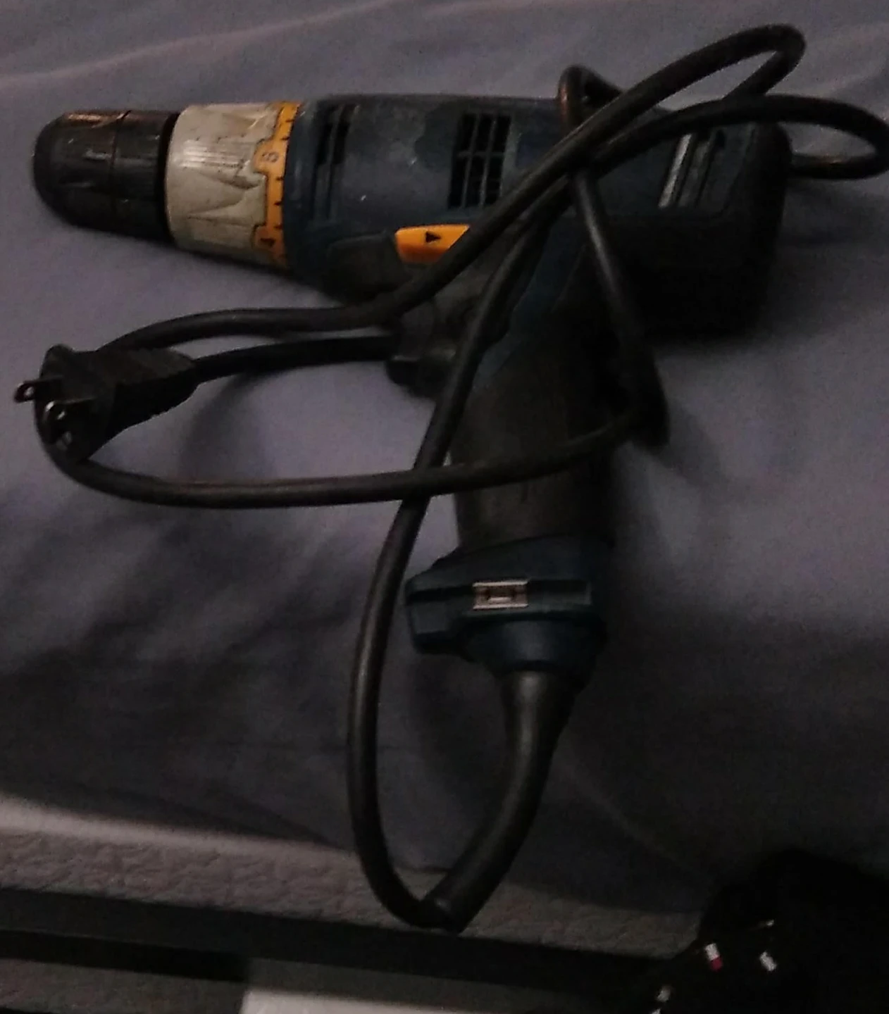 Black and yellow corded drill