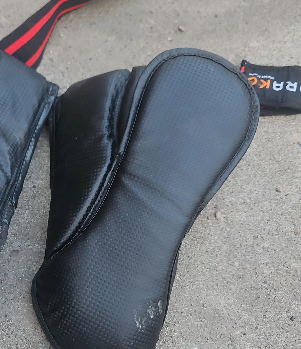 Black padded straps with red accents