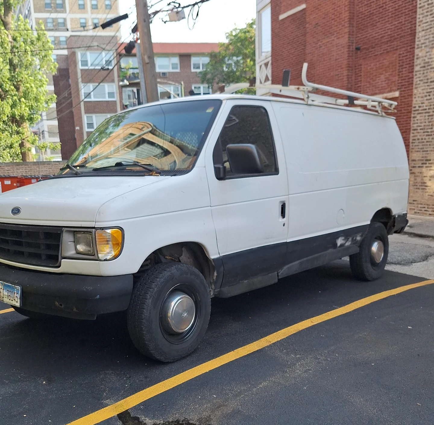 White Ford Econoline Van with Ladder Rack