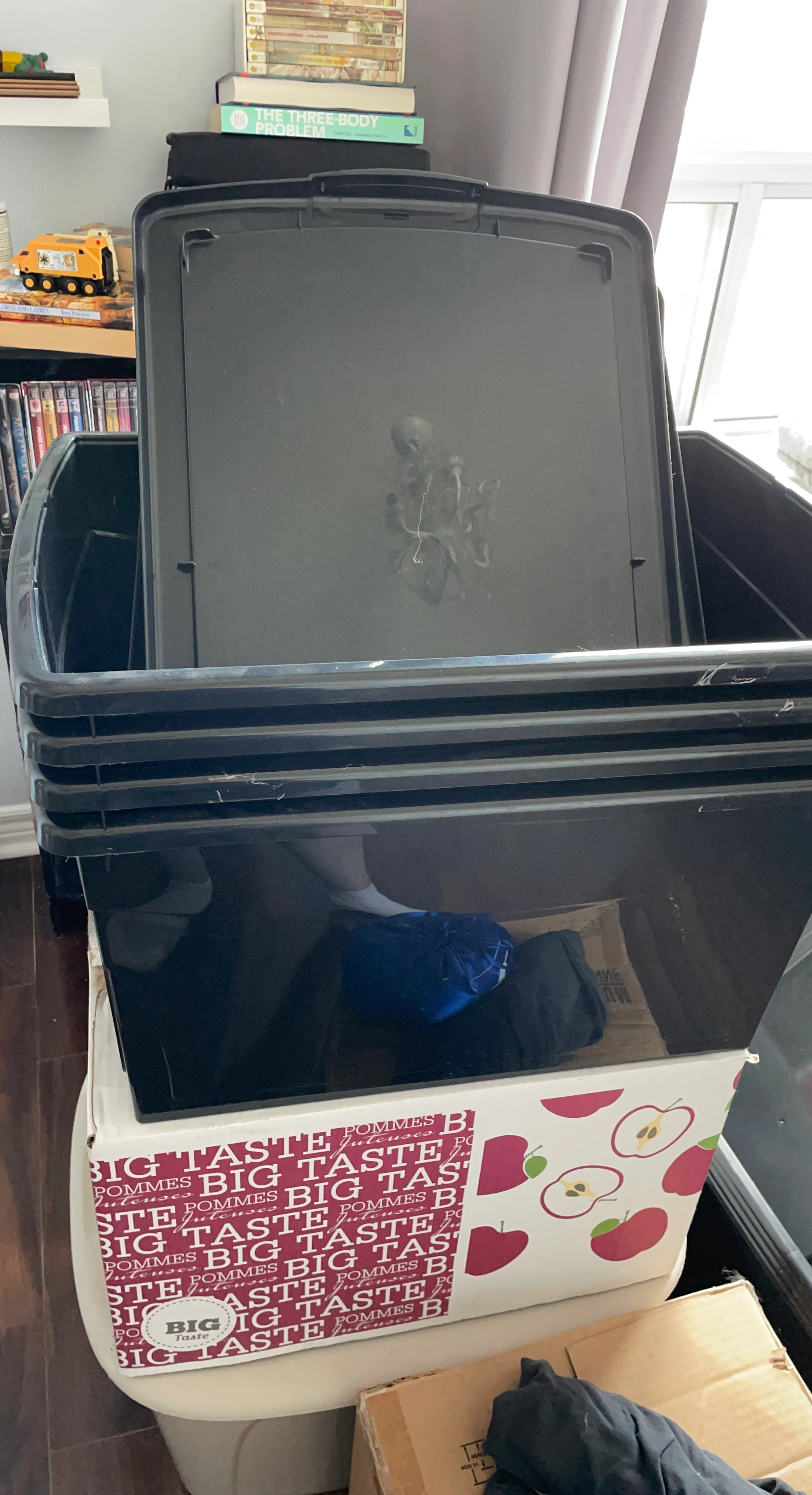 Stack of 4 black storage bins