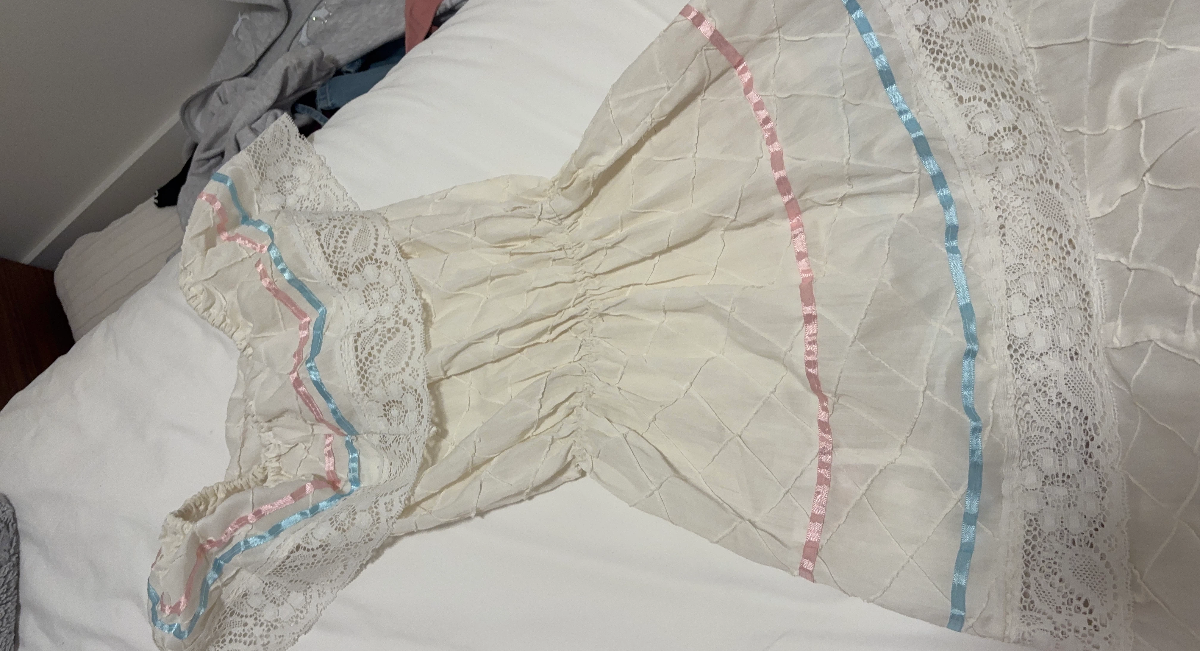 Cream Baby Dress with Pink and Blue Ribbon Accents