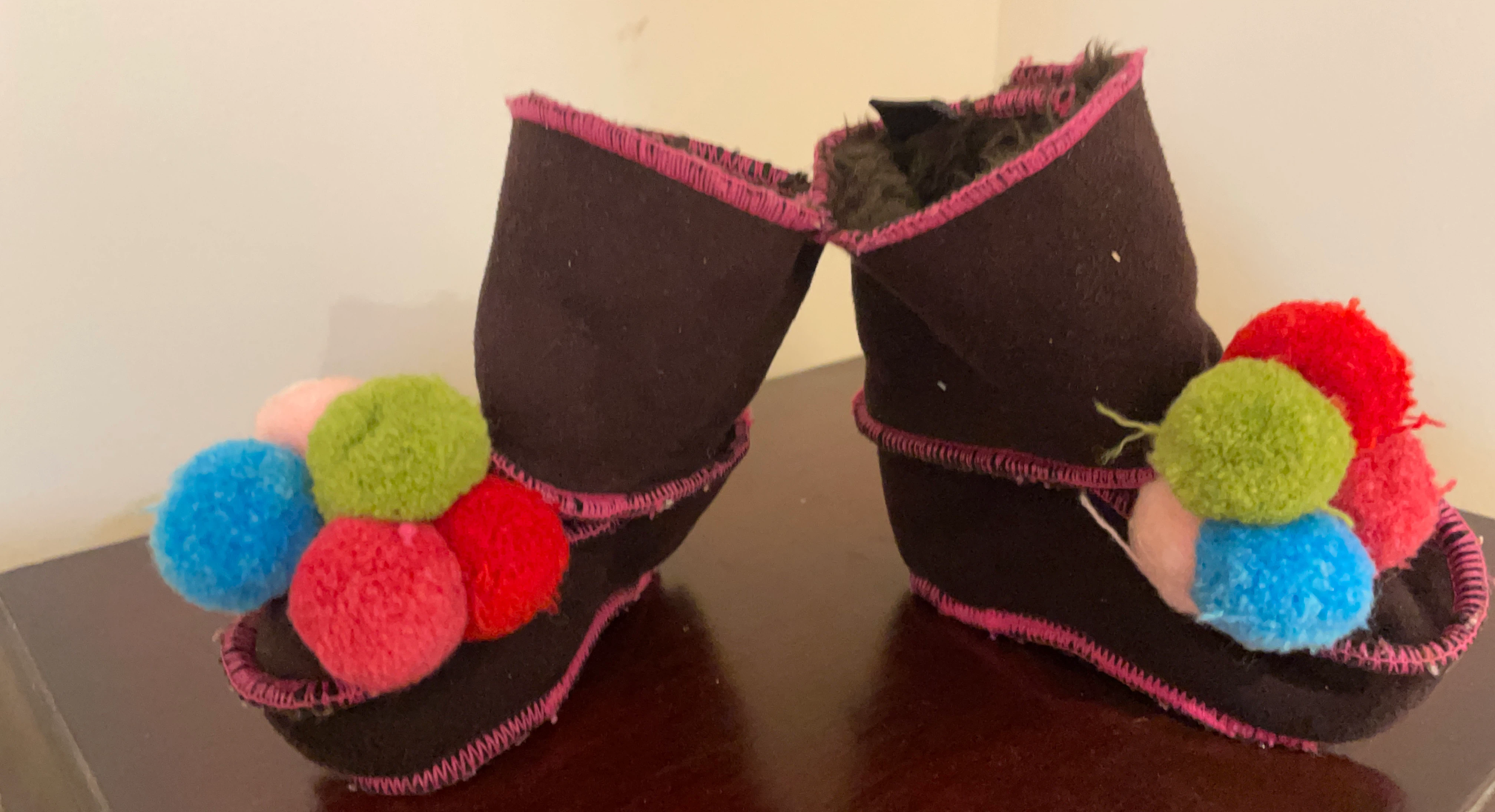 Brown fuzzy slippers with pom poms