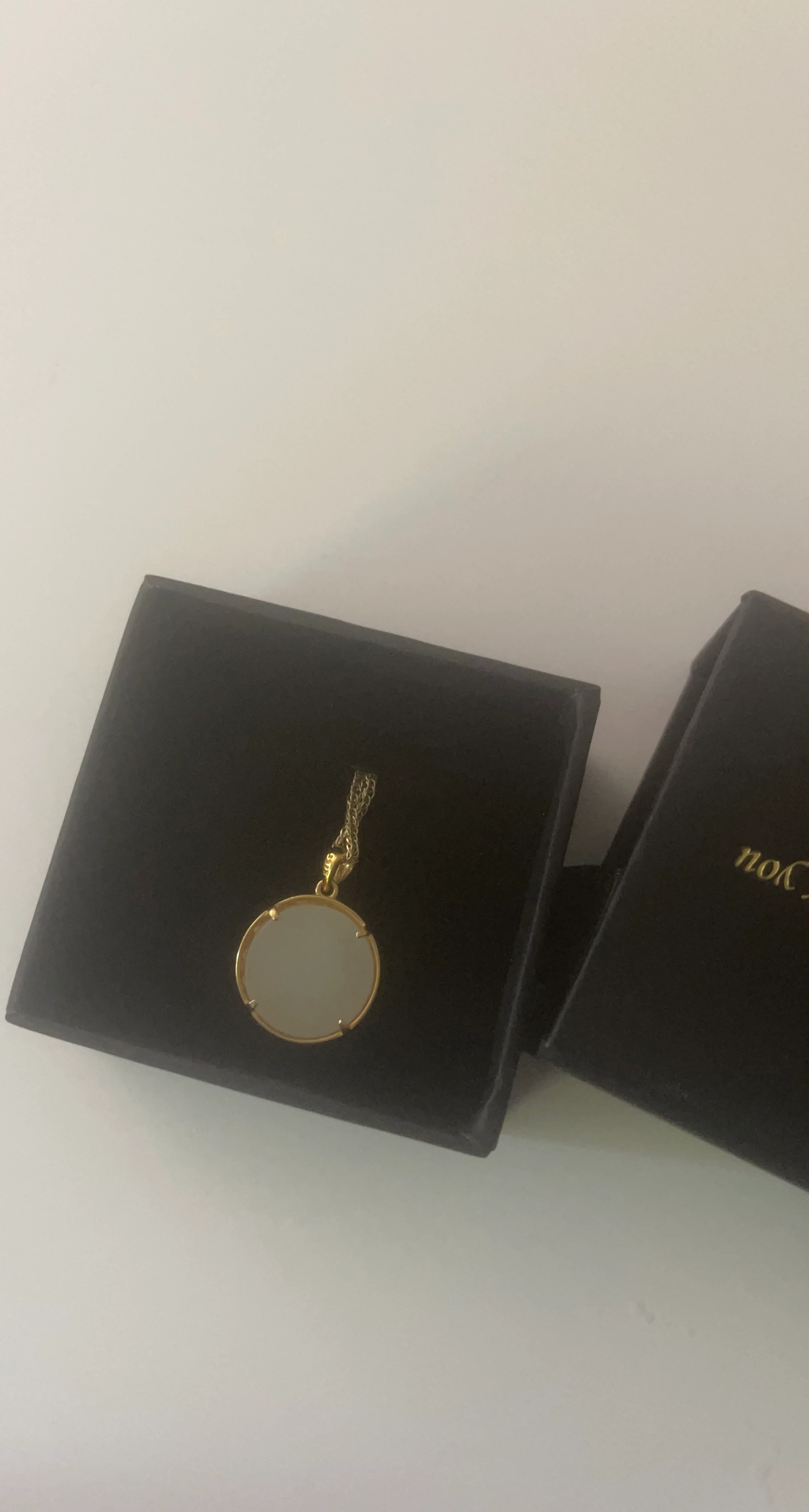 Gold tone pendant necklace with white stone