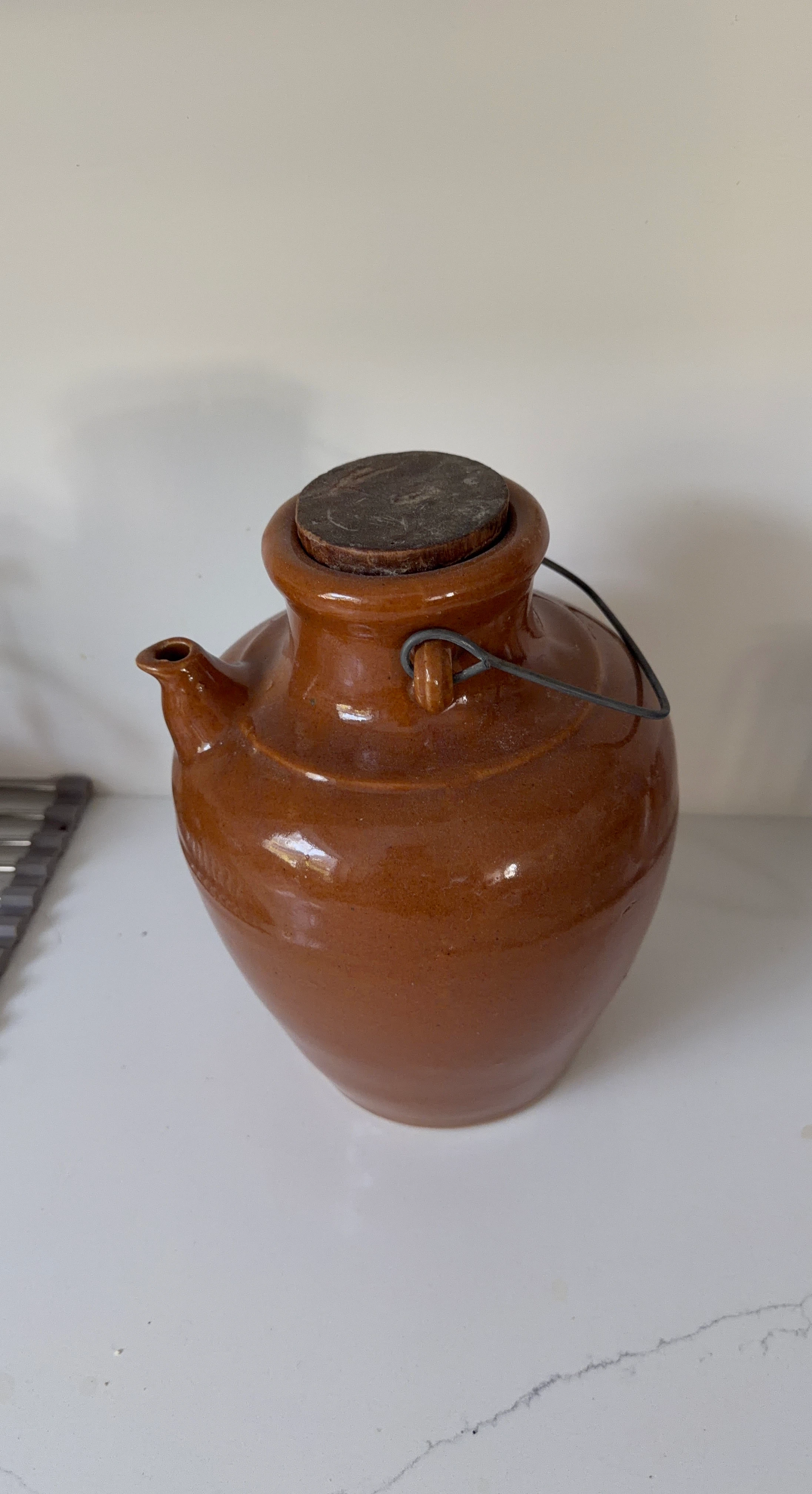 Terracotta jug with spout and lid