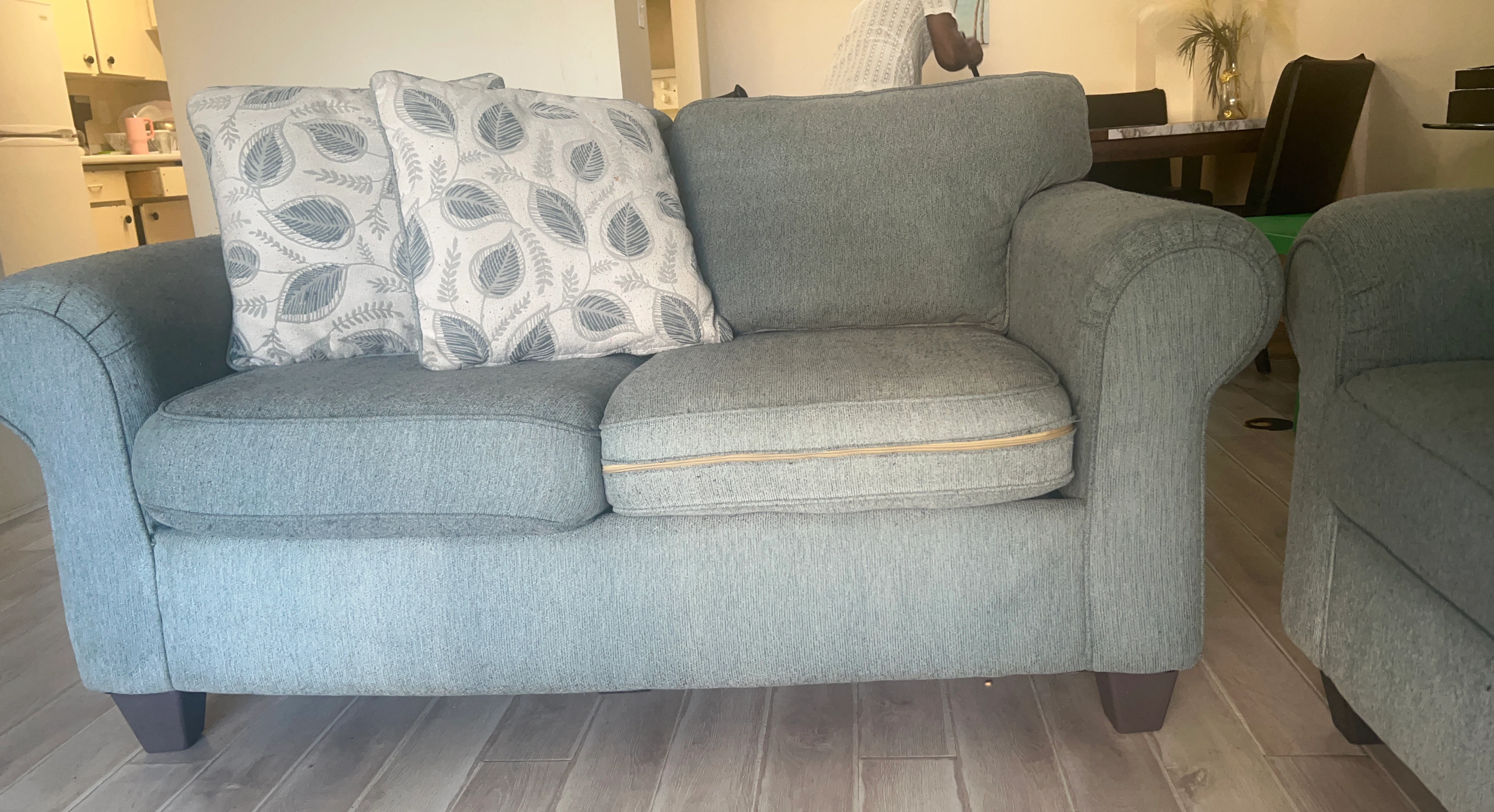 Blue loveseat with decorative pillows