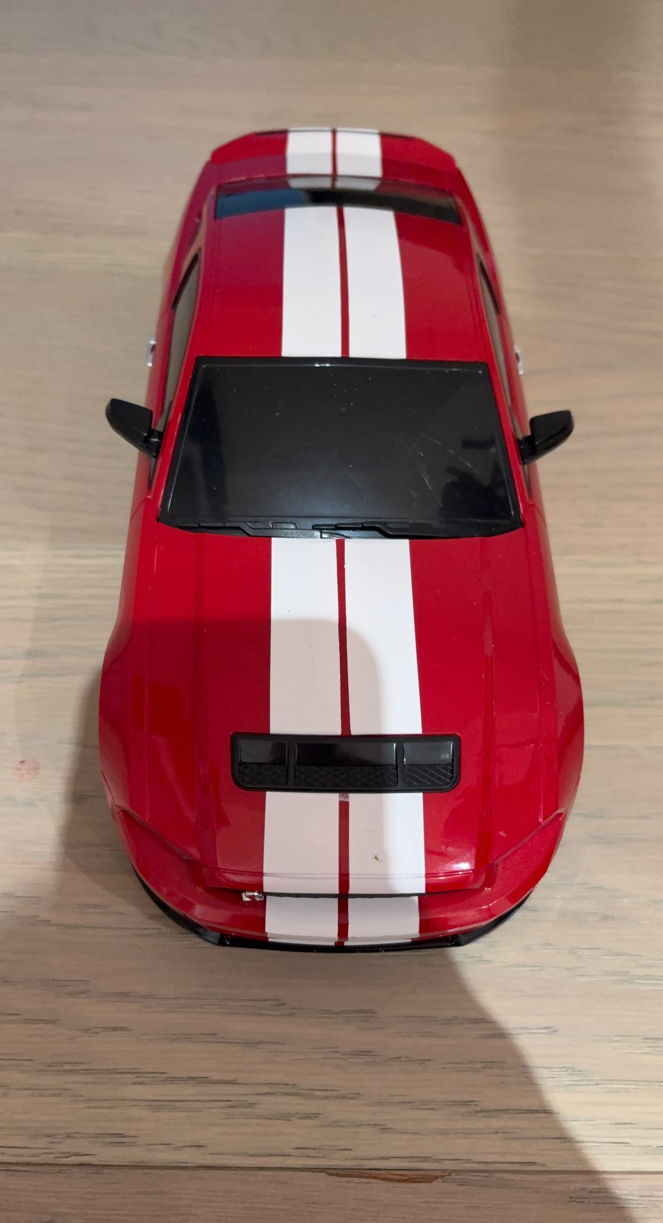 Red toy car with white stripes