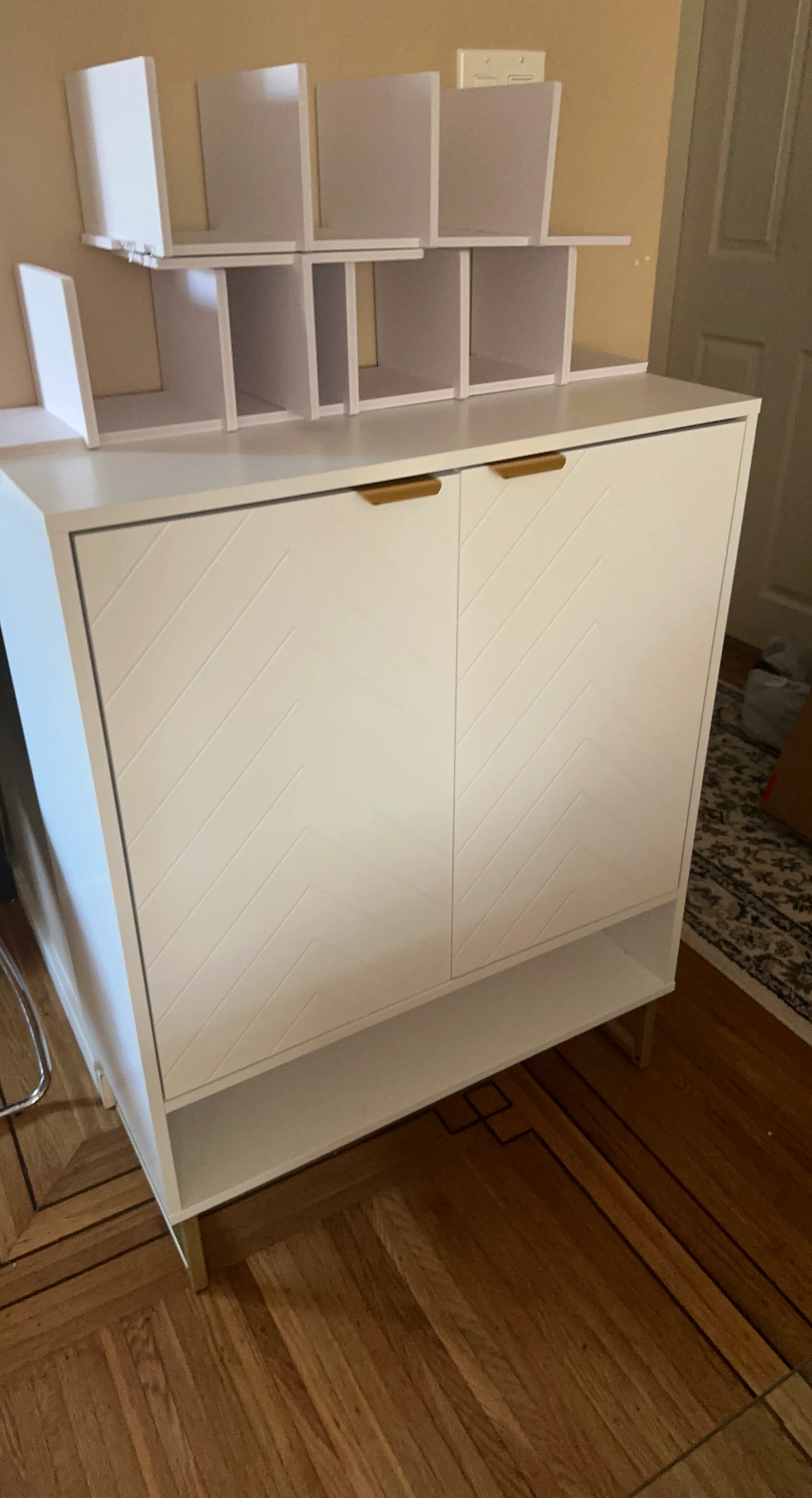 White Cabinet with Gold Handles and Shelving Unit