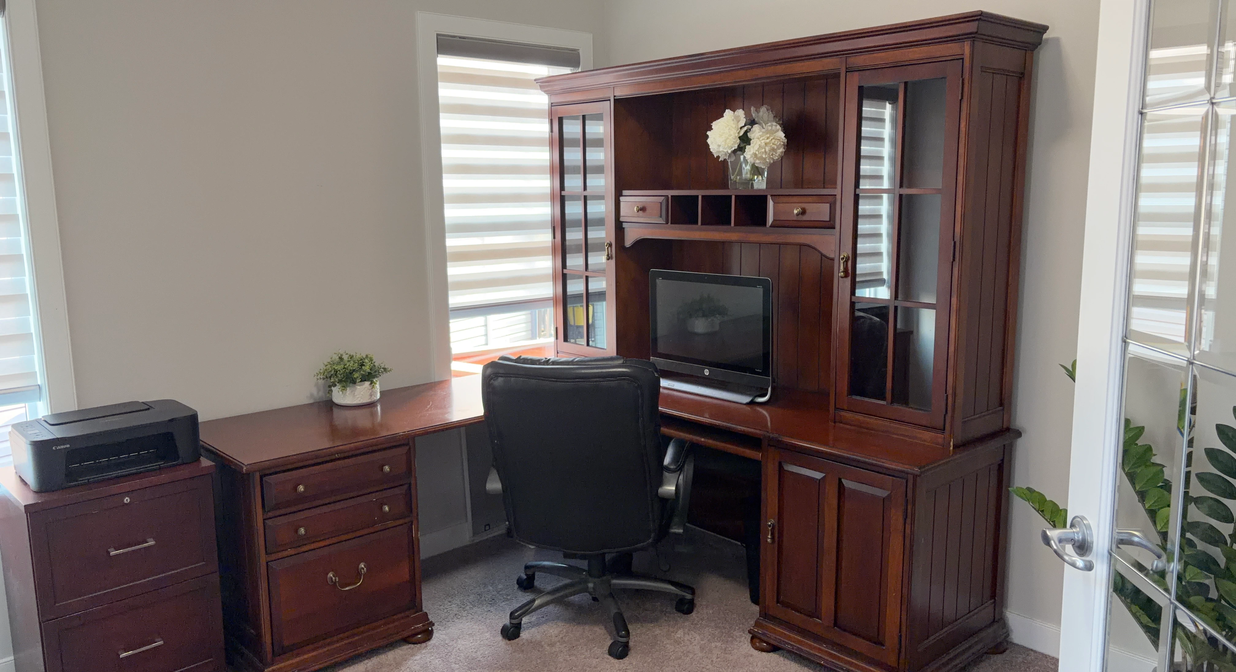 Large wooden corner desk with hutch