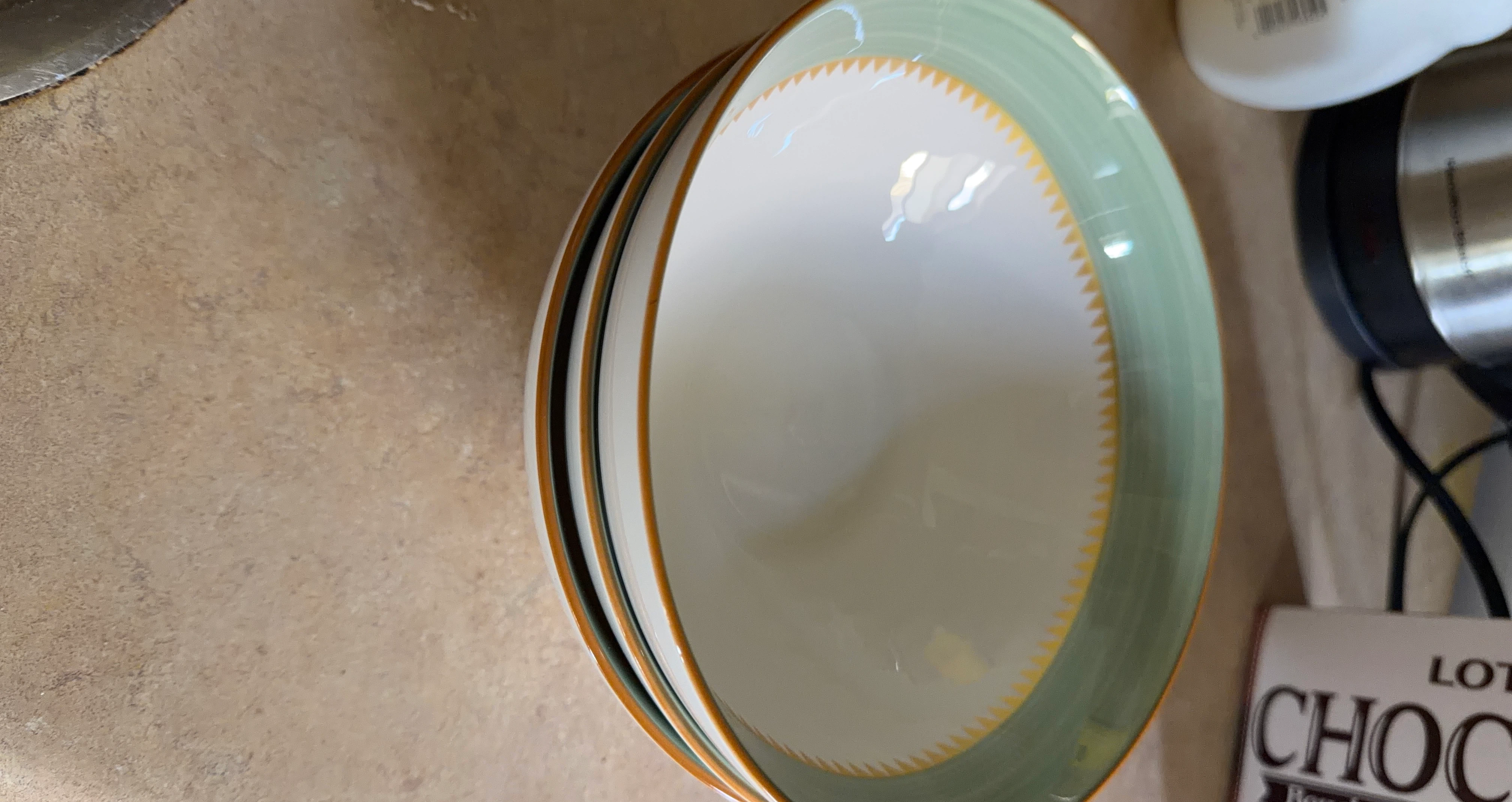 Stack of 3 green and white ceramic bowls