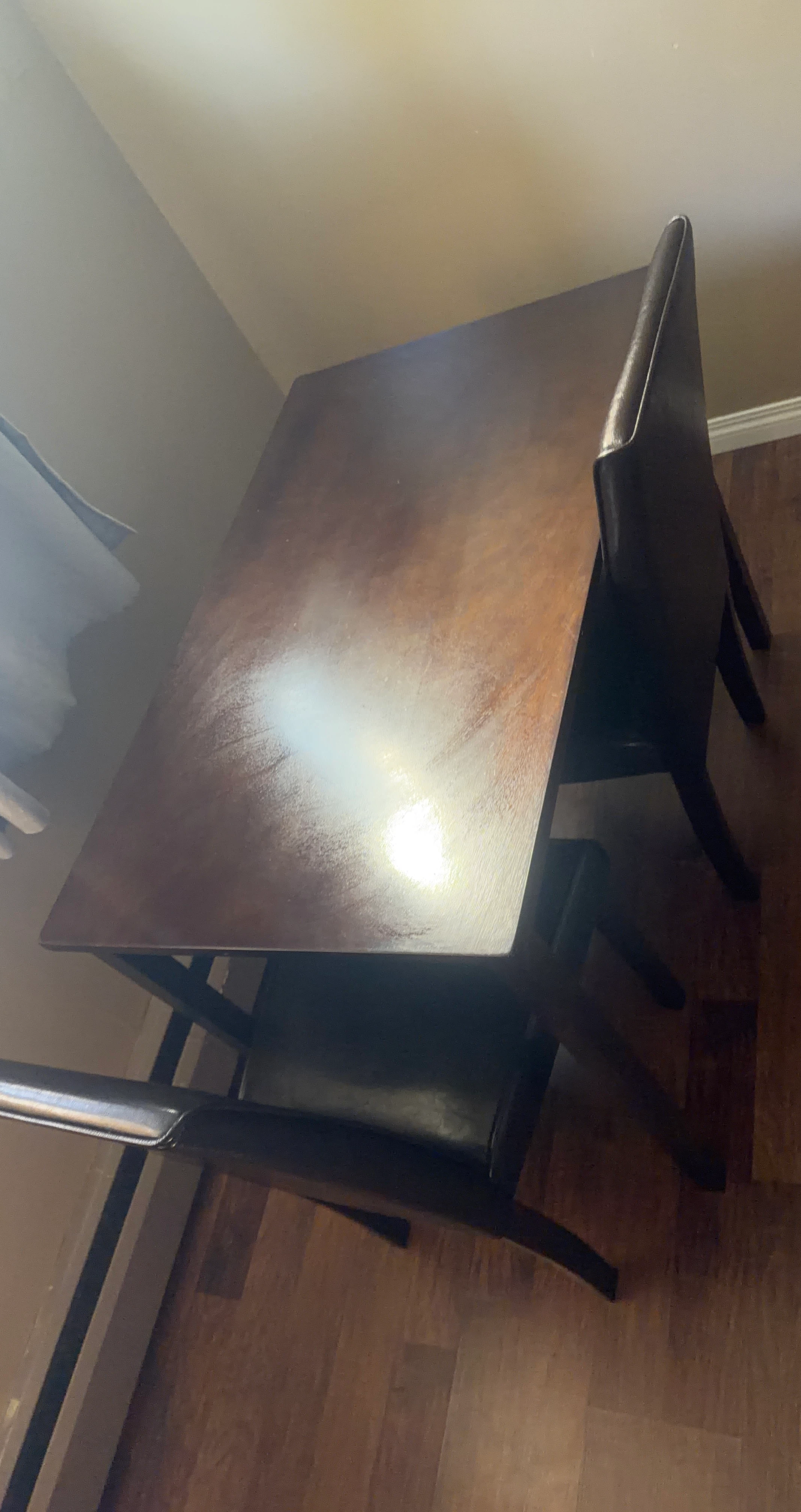 Dark wood dining table with two chairs