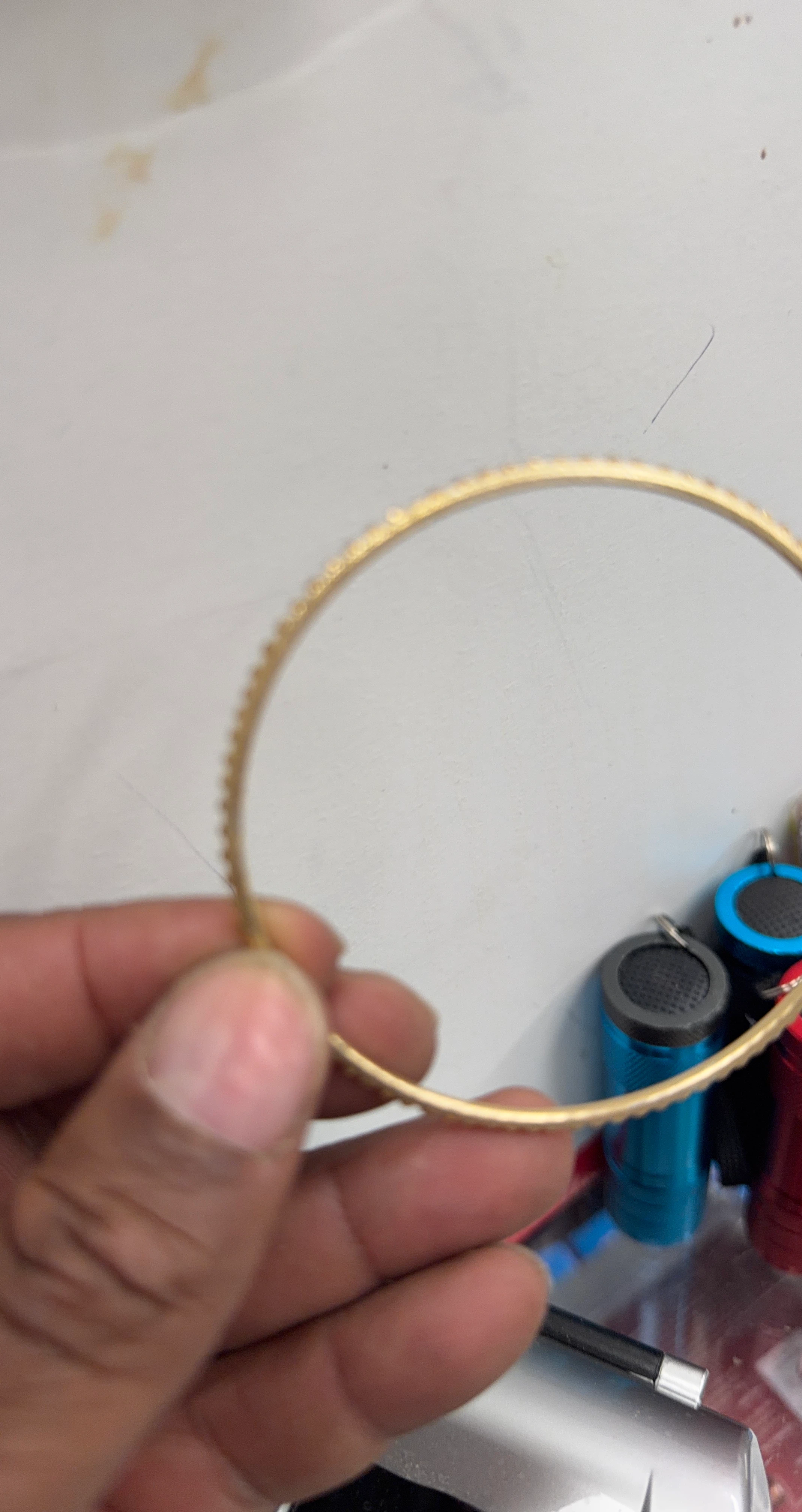 Gold tone bangle bracelet with textured detail