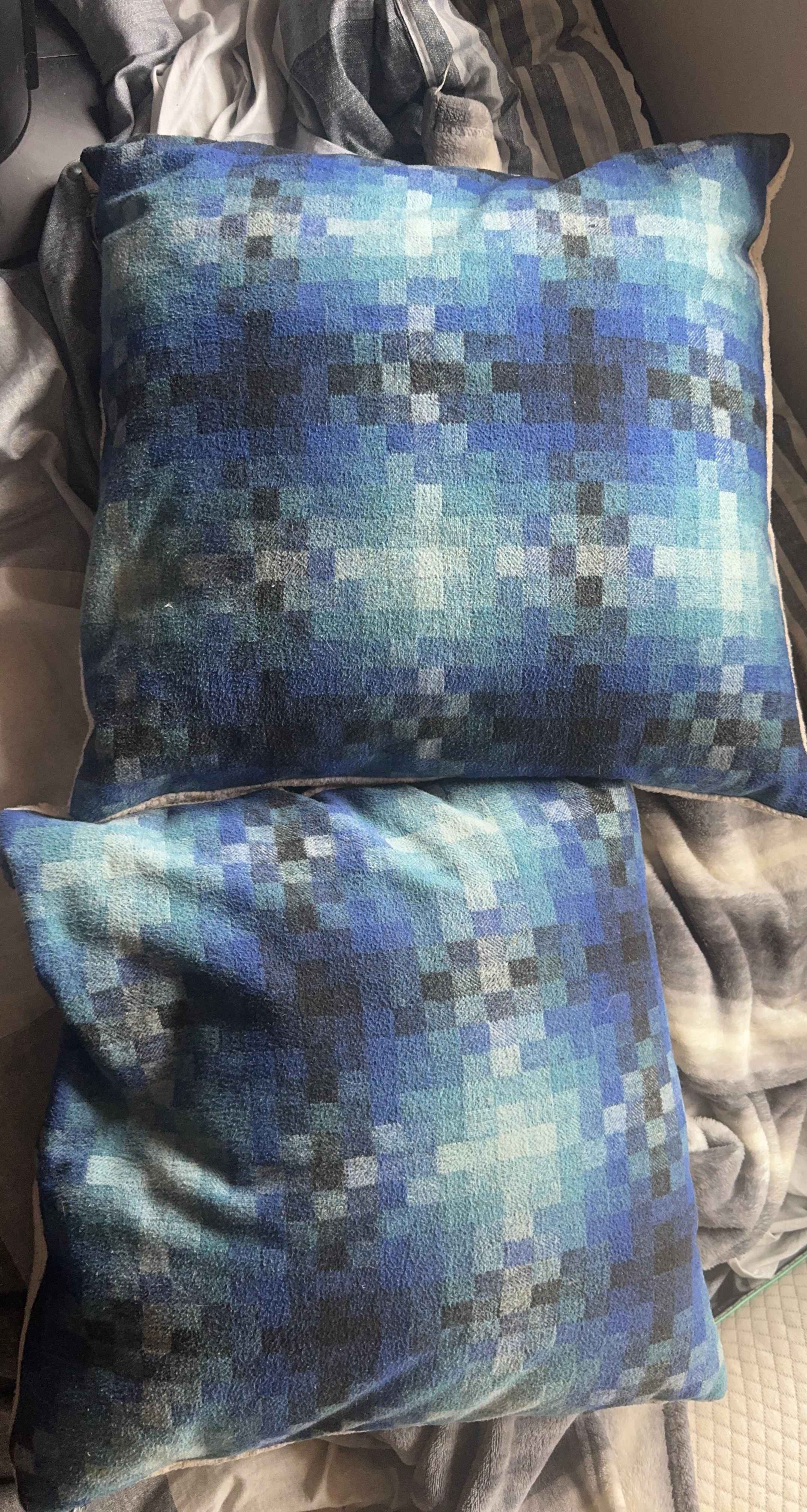 Two blue pixelated throw pillows