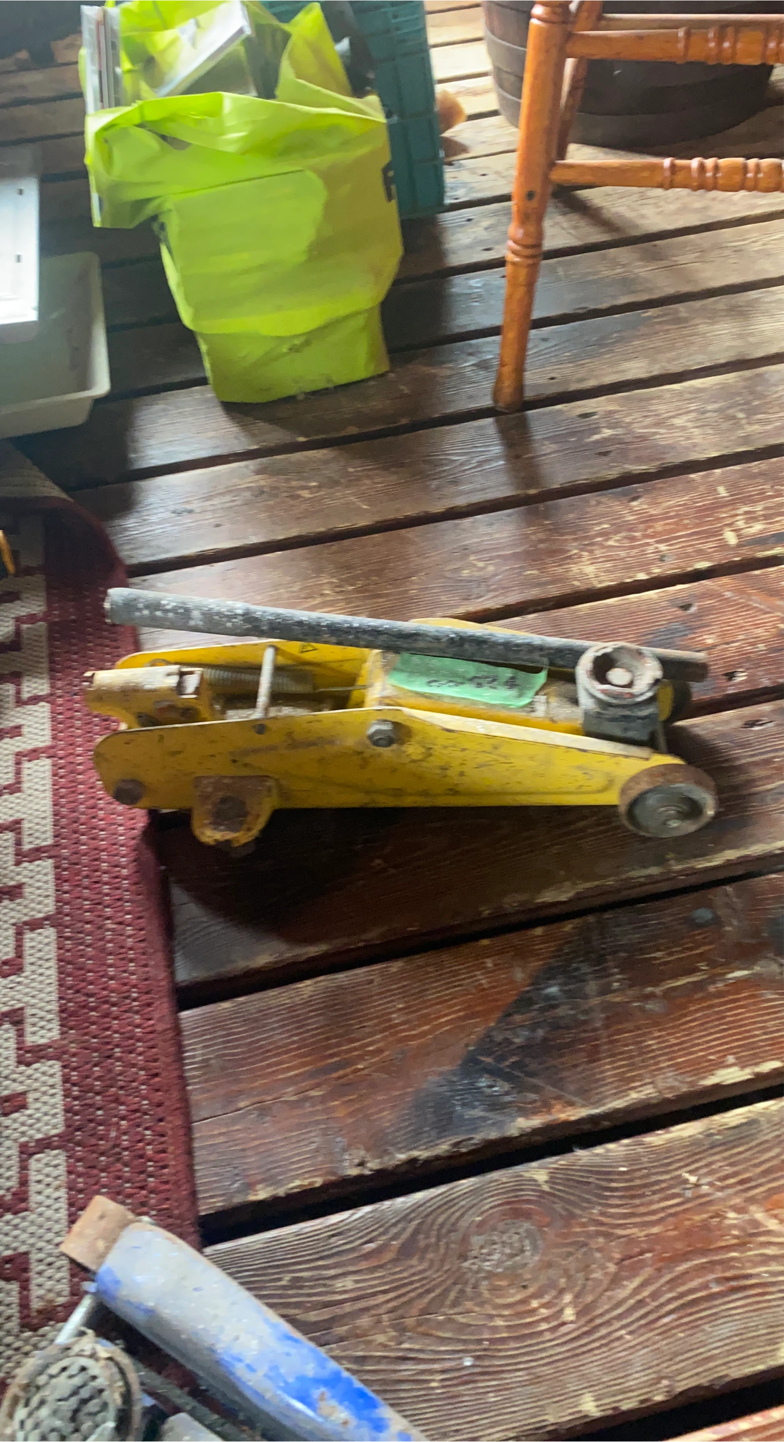 Yellow hydraulic floor jack