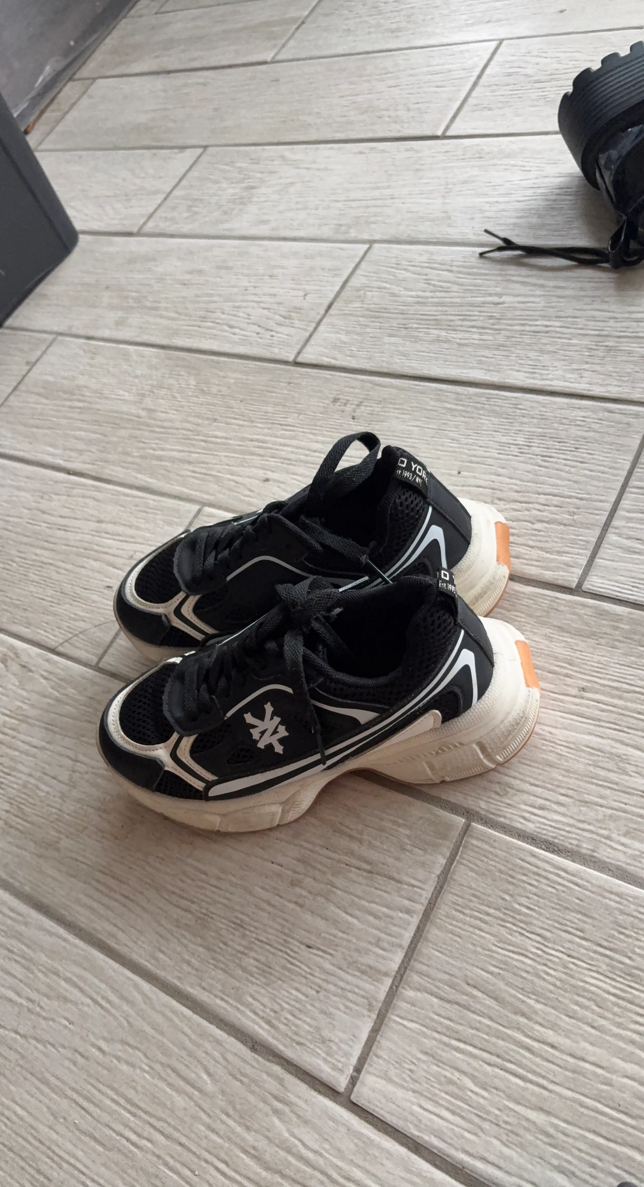 Black athletic shoes with white accents