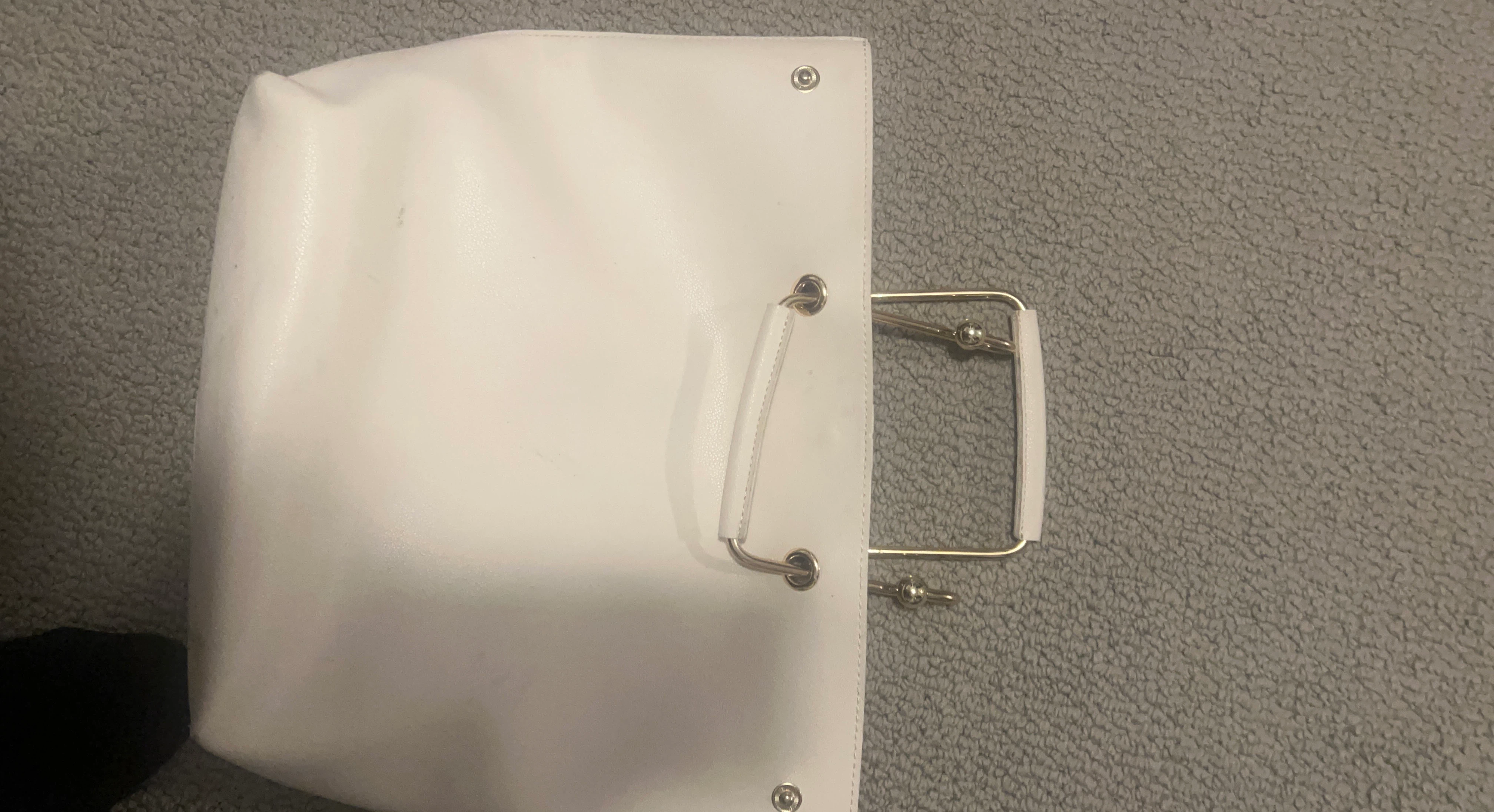 White handbag with metal handles